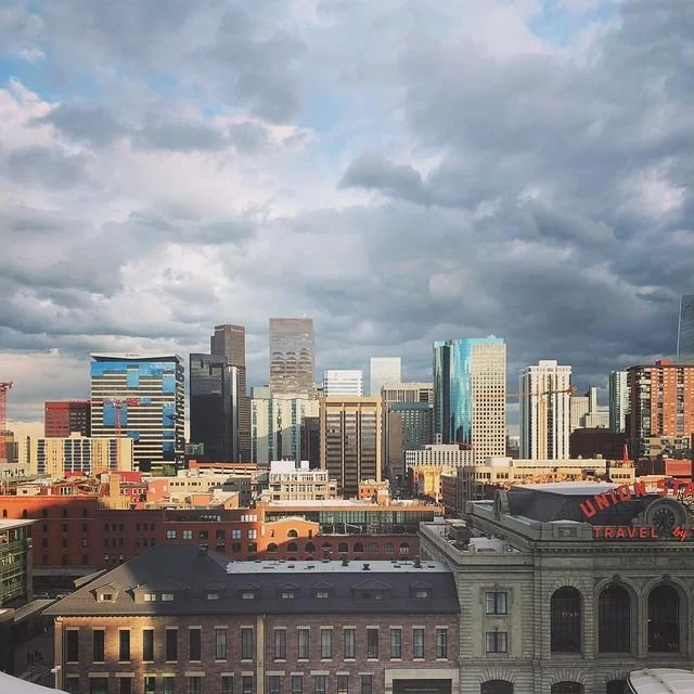 View of a city skyline with high-rise buildings under a cloudy sky