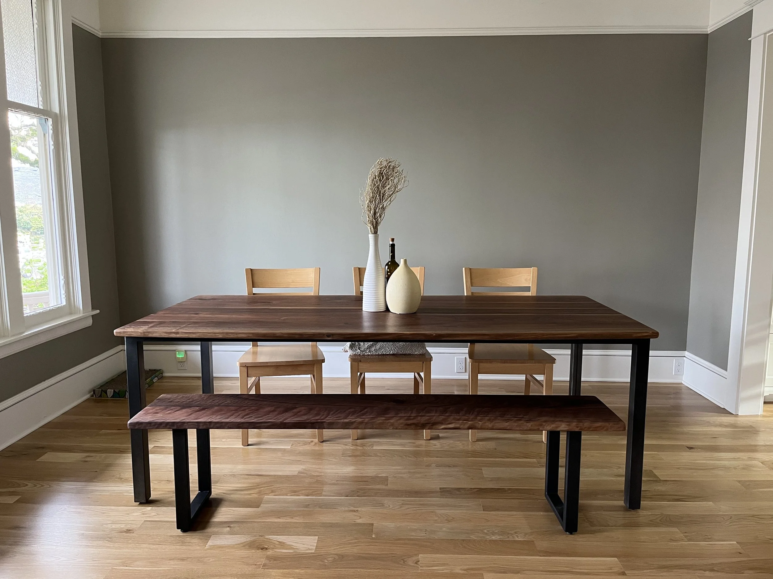 Custom walnut dining table with Parsons style steel base, handcrafted in Portland Oregon