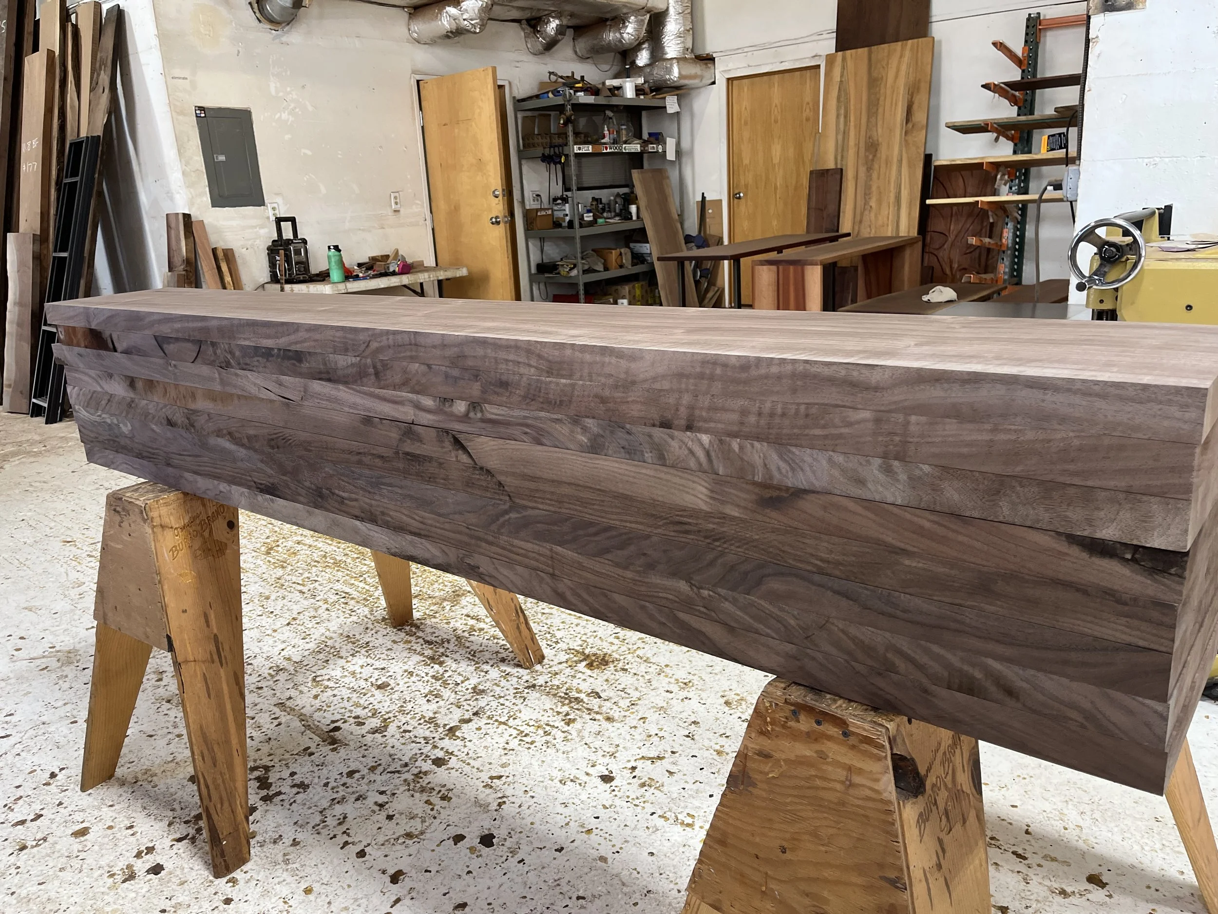 Stacked milled Oregon black walnut lumber with figured grain, hand-selected at Goby Walnut in Portland