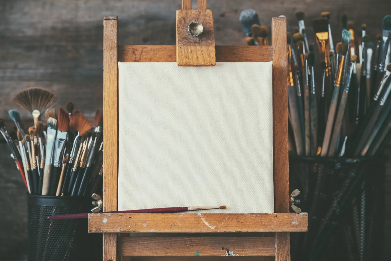 Artistic-equipment-in-a-artist-studio-empty-artist-canvas-on-wooden-easel-and-paint-brushes-Retro-toned-photo.-668060762_5196x3464_Web.jpeg