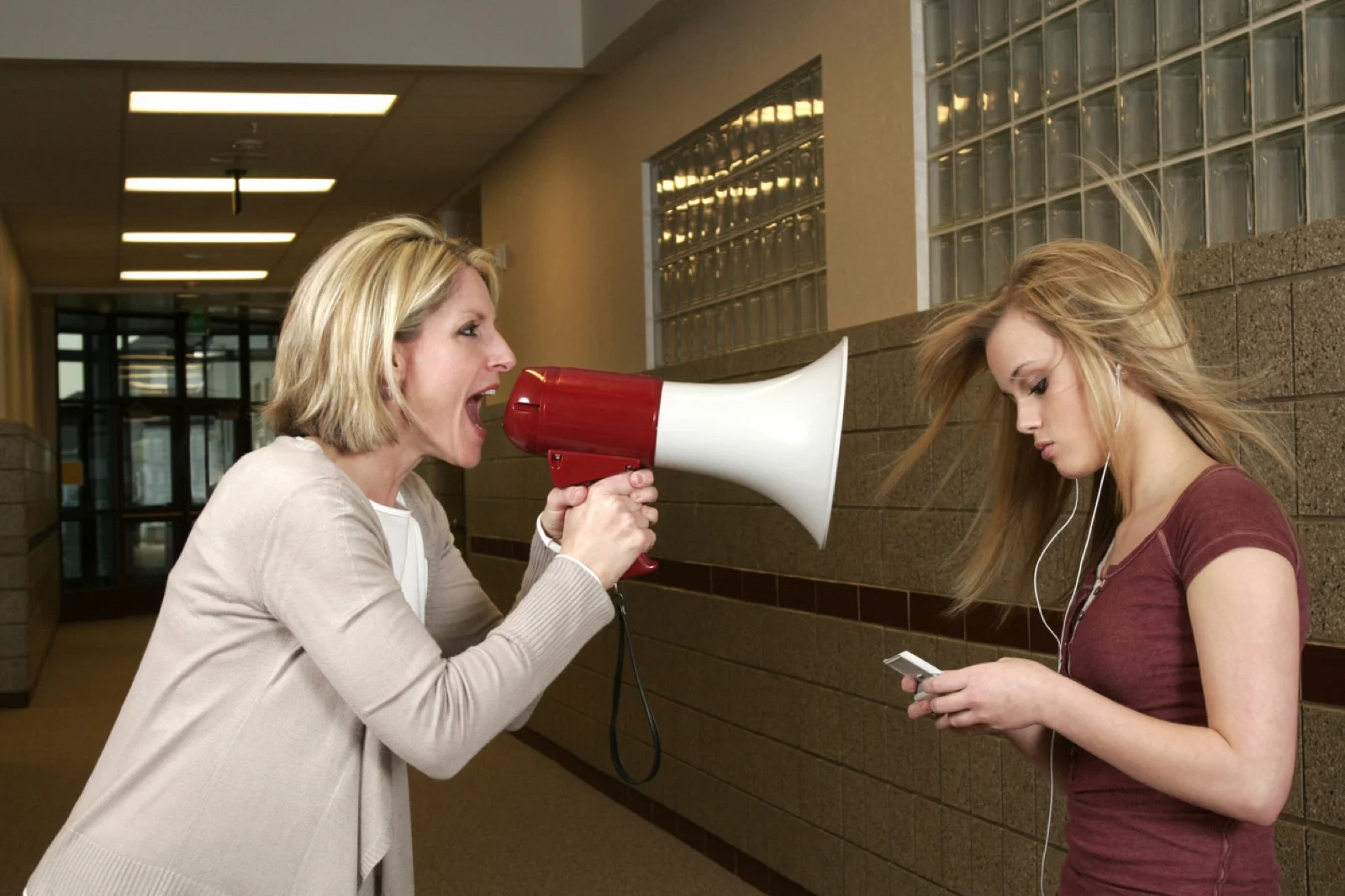 Woman-yelling-through-a-bullhorn-at-an-unfazed-teenage-girl-172808685_1258x839 (1)_Web.jpeg