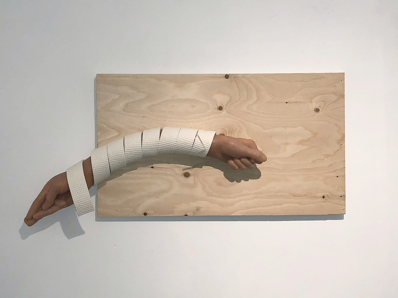 Maryam Jafri. Schadenfreude (2017). 32"x 4"x 18". plywood, silicone, Acupuncture needle (in casing), yoga mat