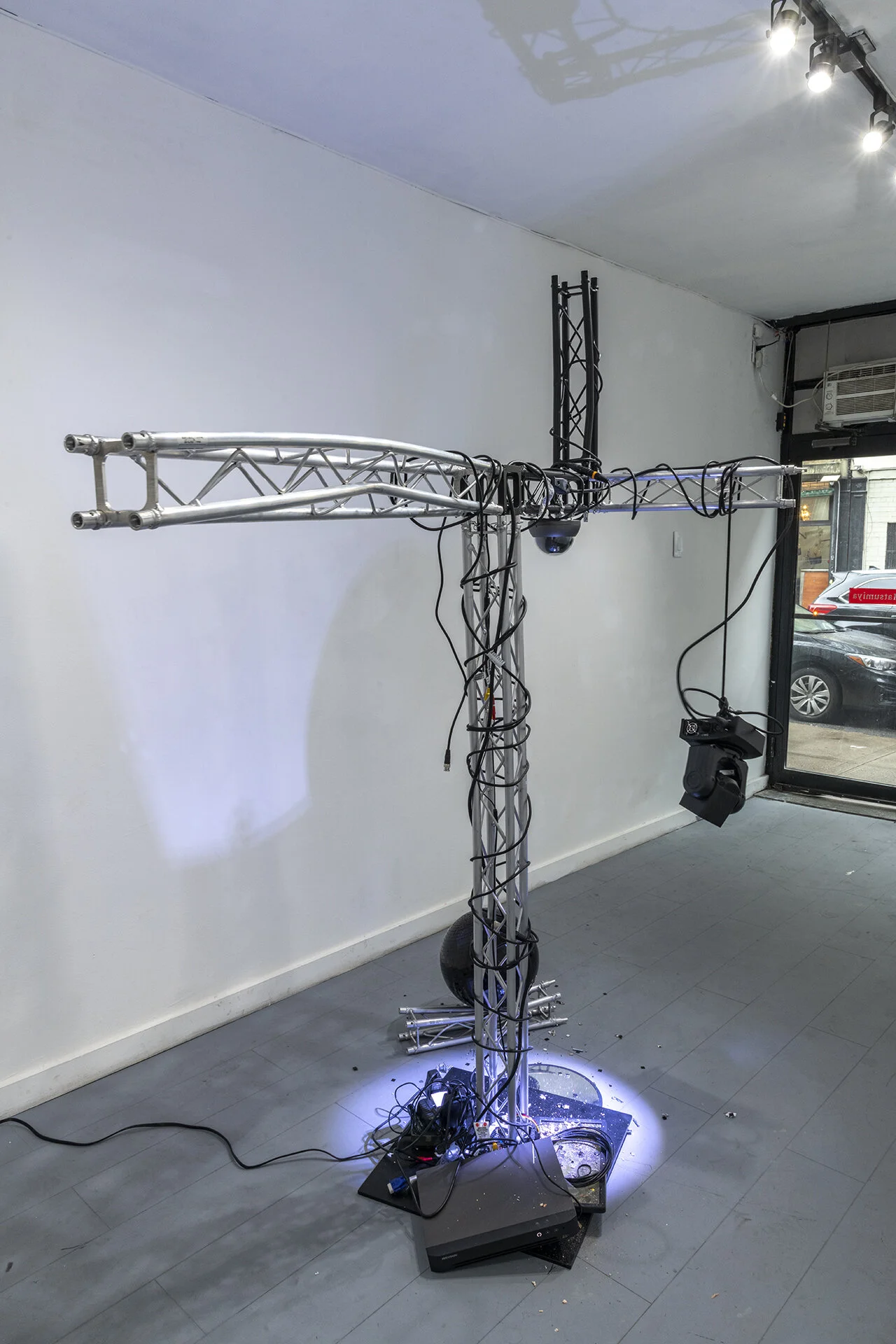 Craig Kalpakjian Damage Control, 2019 Lighting truss, surveillance mirror, security camera, ADJ stage light, monitor, black mirrored ball, detritus 84 x 74 x 42 inches