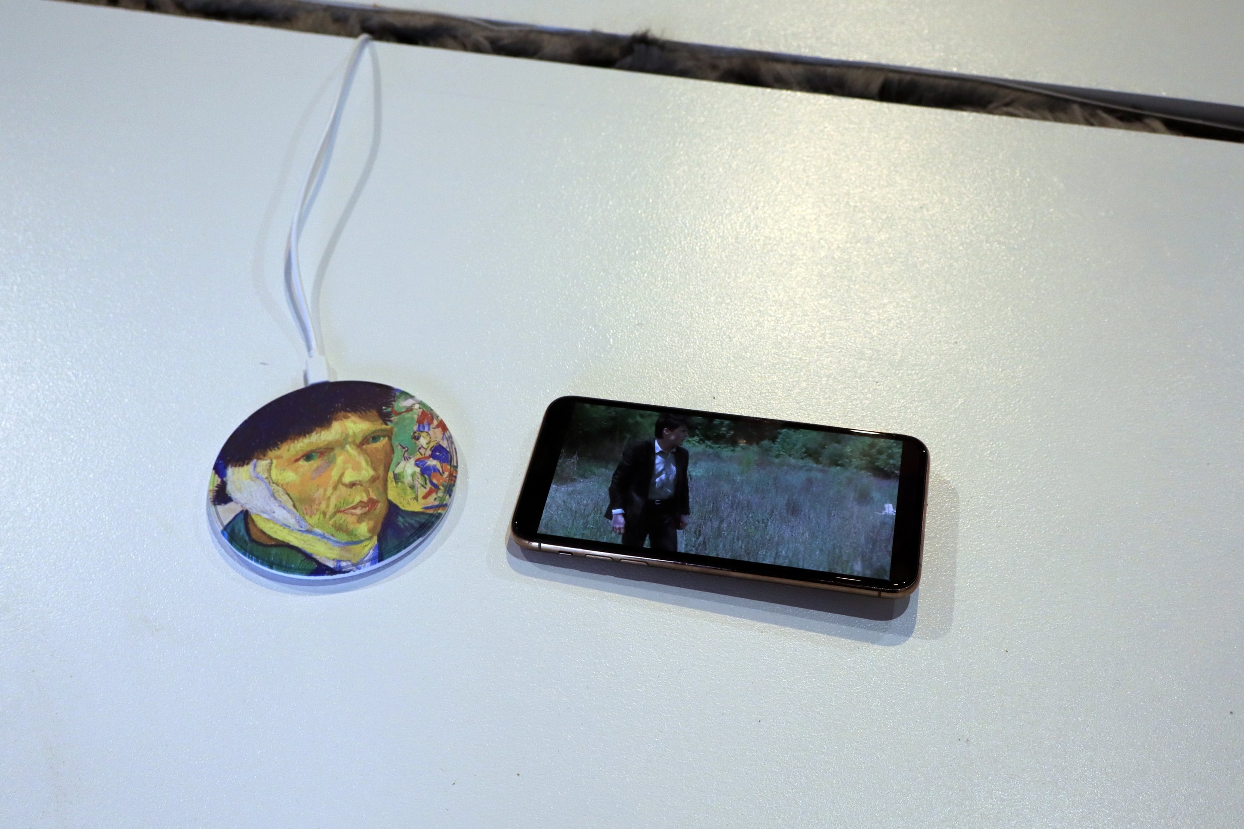   Maryam Jafri   Some Medicate, Others Meditate( No Lithium, No Work)  edition of 3 + 1 AP 2023 Custom-printed mousepad, space bar (No Lithium, No Work)     Smartphone charger with custom print of Van Gogh painting with his ear cut off and a refurbis