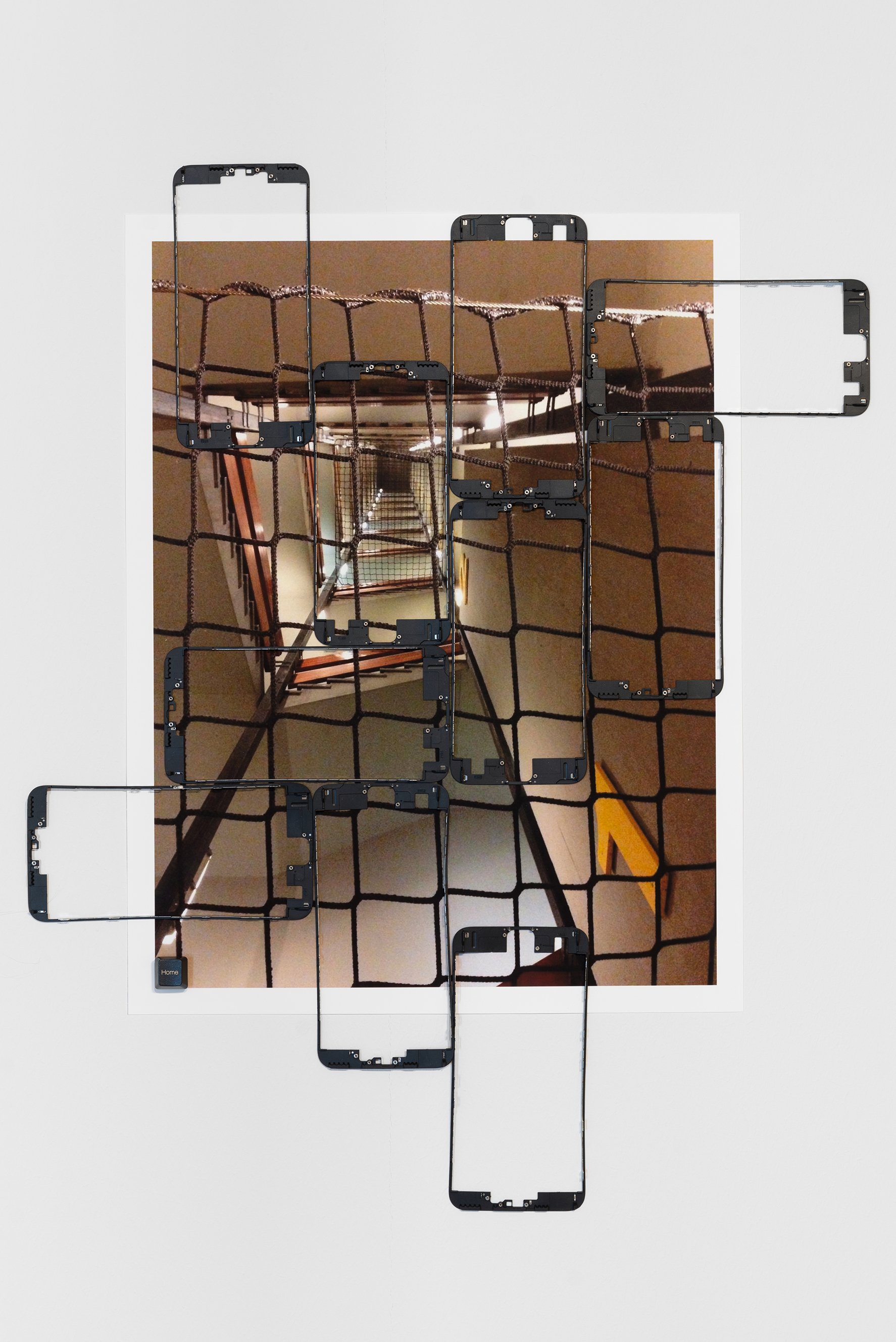   Maryam Jafri   Home (No Lithium, No Work)  edition of 3 + 1 AP 2023 Archival inkjet prints, smartphone bezels, key cap 13¼ x 17¼ in. &nbsp; 33.66 x 43.81 cm MJ0143  Photo of anti-suicide nets installed inside workers dorms by Apple-supplier Foxconn