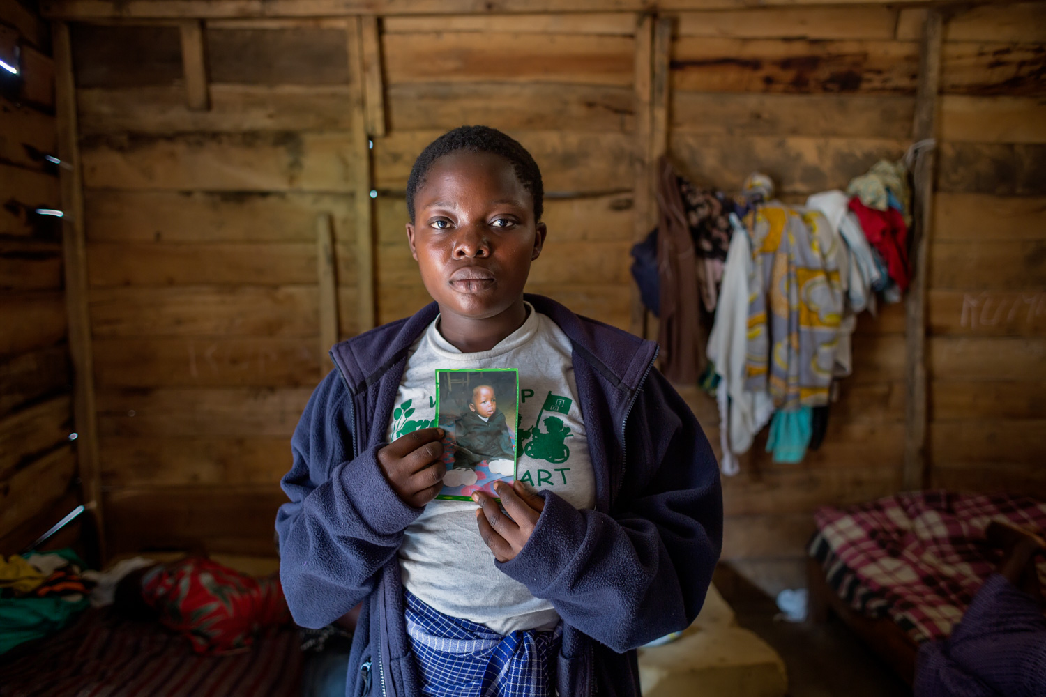  A victim, 18 years old, holds a photo of her son, Arlain, who died as a consequence of the events of November 2012. FARDC attacked houses all over the &nbsp;Minova, including a center for rape survivors, run by human rights activist and rape survivo