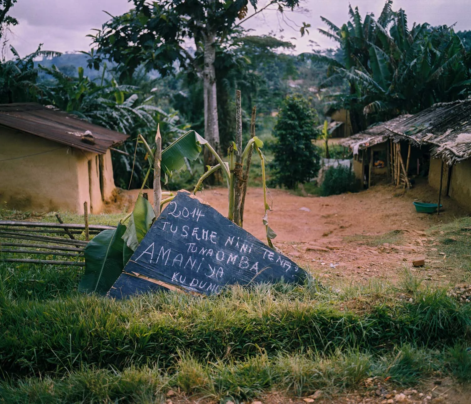 On New Year's Eve, a roadside sign reads, "2014, what shall we say again? We ask for lasting peace." Dec. 31, 2013. Lulingu, South Kivu, Democratic Republic of the Congo. 
