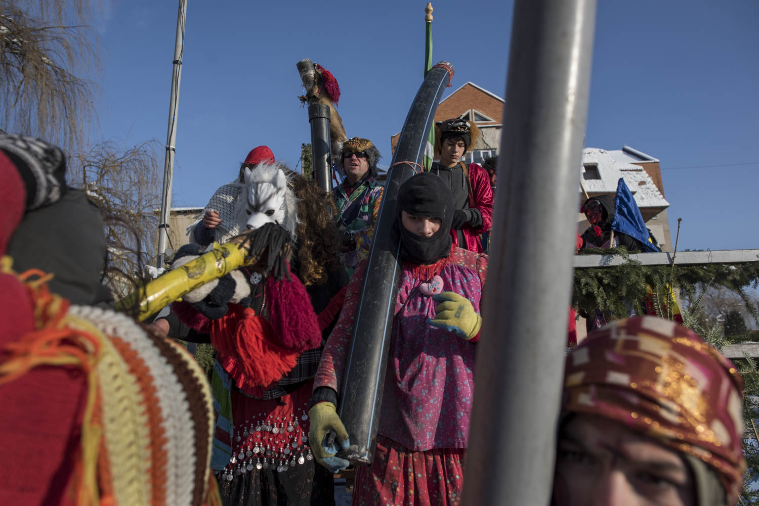  Locals dressed as masked gypsies exit the stage set up in central Comăneşti as part of the town's annual Bear Parade and Competition. In the past, when the bear dance was a gypsy tradition, ghoulishly masked dancers would enter a household just befo