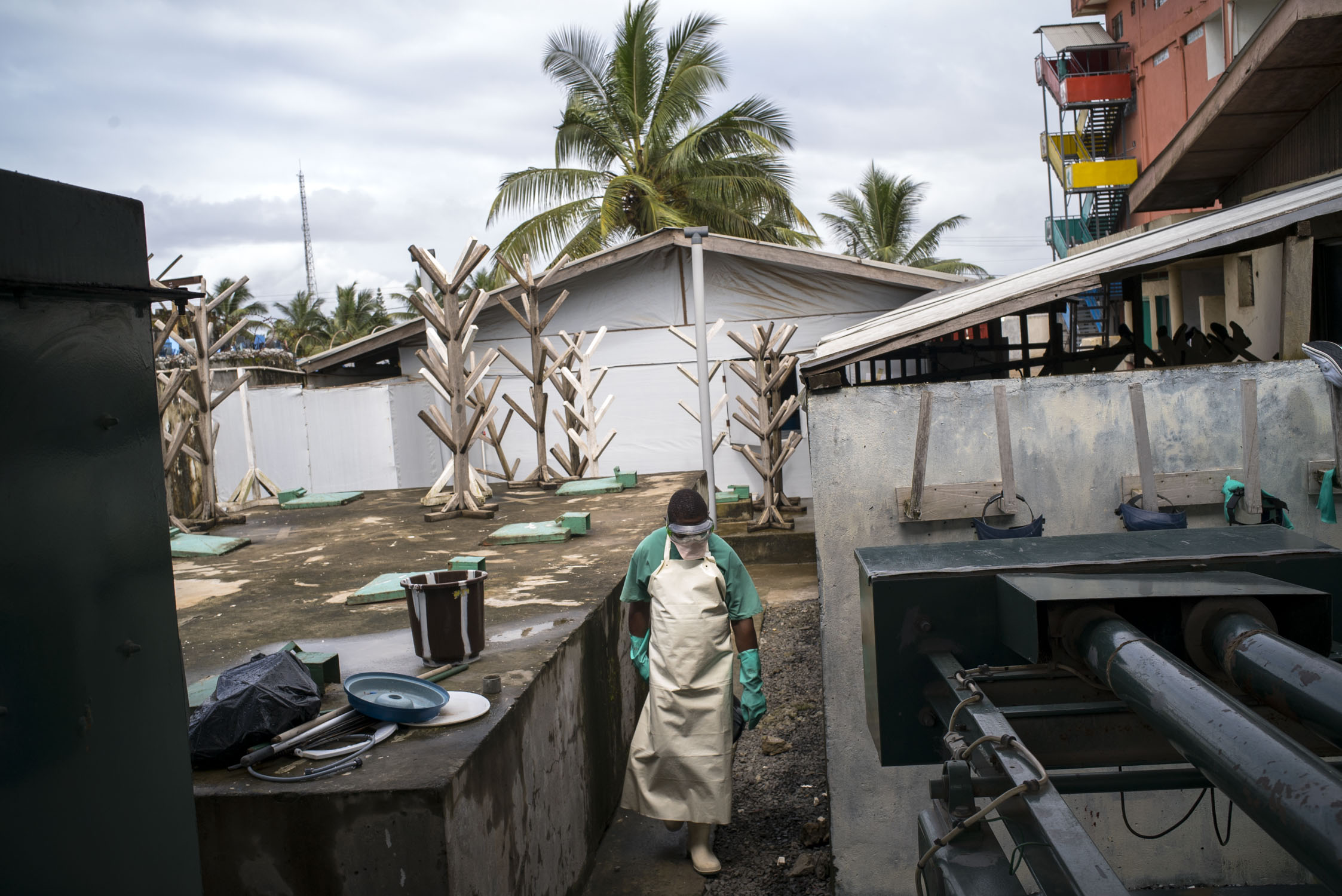  A sanitation worker walks though the back courtyard of an MSF hospital in Monrovia, Liberia. In the aftermath of the the ebola epidemic of 2014/15 that left an estimated 4800 dead in Liberia, the hospital adheres to especially strict routine sanitat