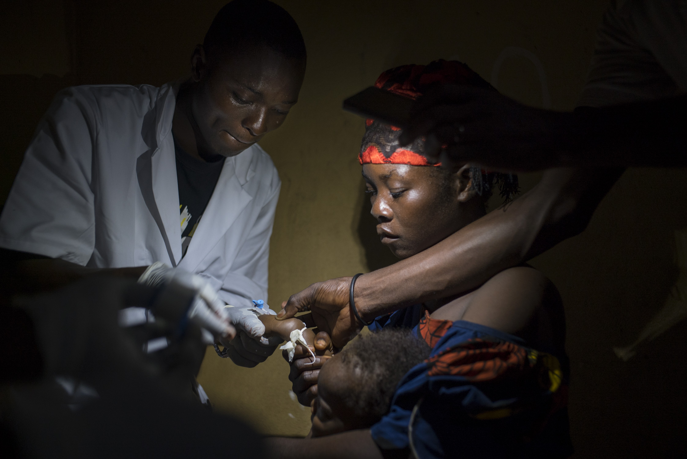  Late in the night, Nurse Dieumerci Ngame administers a blood transfusion to five-month old Adji Yanzambe, who receives treatment for anemia and malaria in the MSF wing of the hospital in Monga, a town in a remote northern part of the Democratic Repu