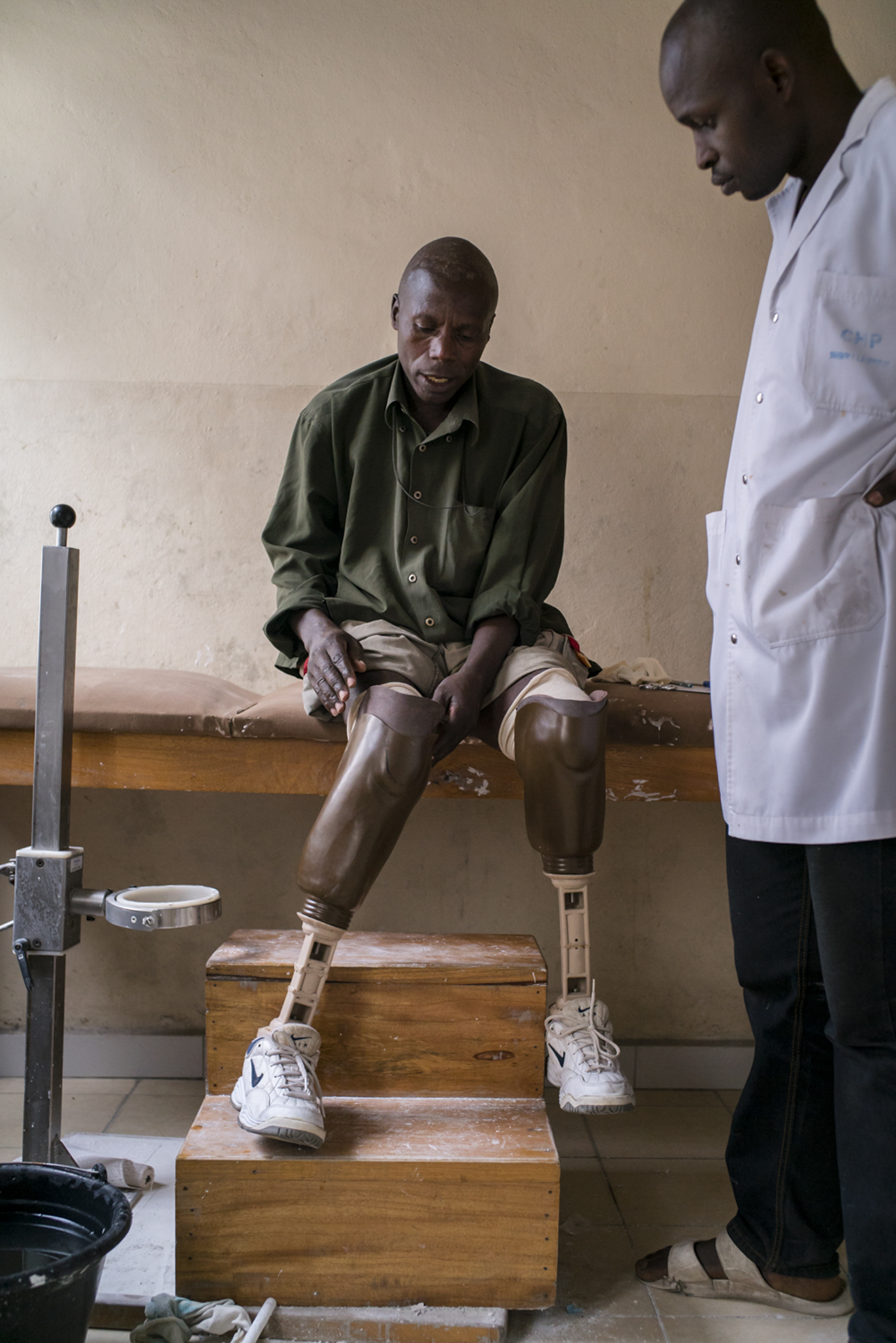  Augustin Semayinga Rukara, 51, a double amputee and father of eight, he puts on his prosthetic limb at a doctor's office. Augustin’s village of Mpati, in Masisi territory of North Kivu,&nbsp;was attacked in June 2013 and he lost his right leg after 