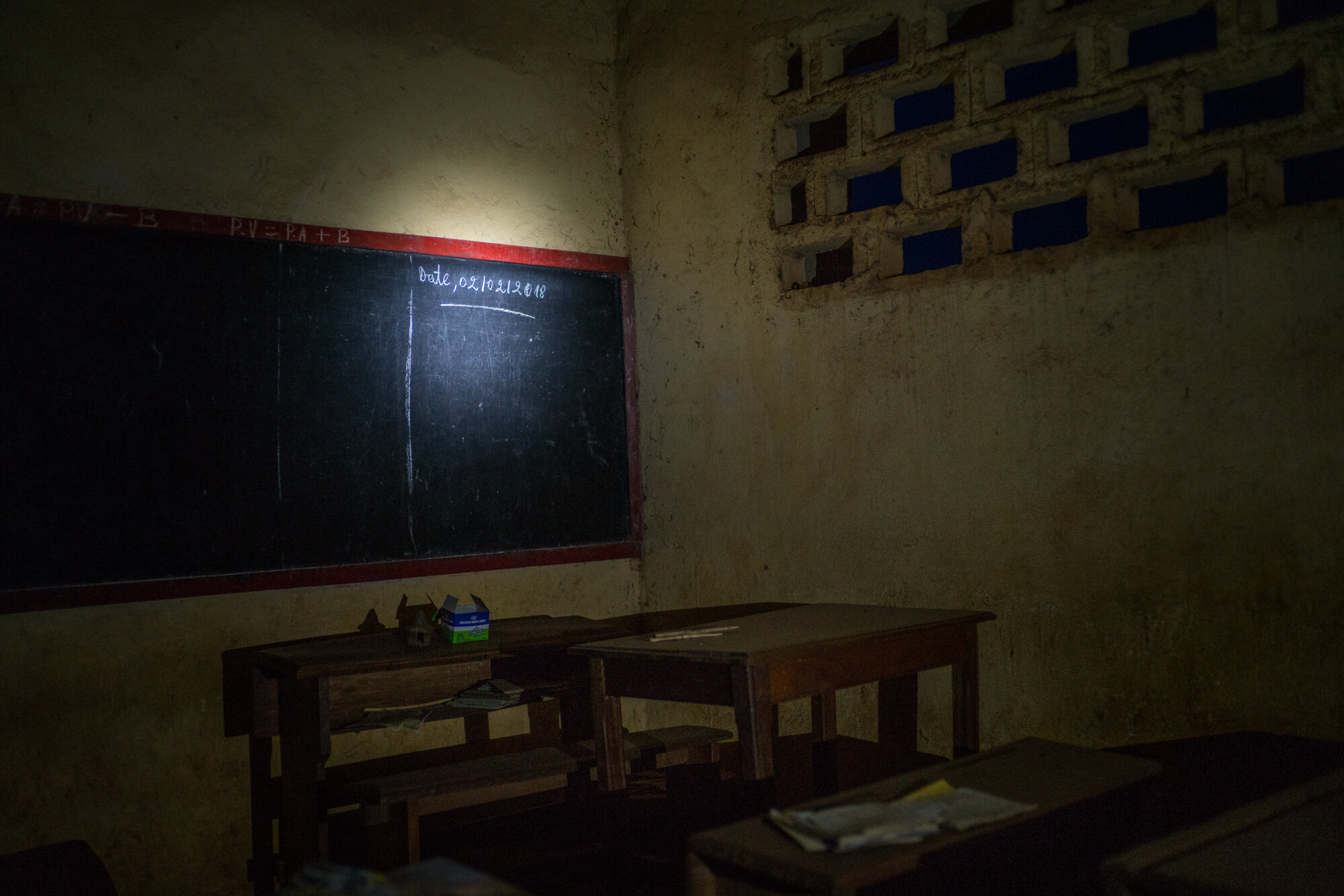  The date on the blackboard of a ransacked classroom marks the last time class was held at the school in Lita, a town deserted and in ruins after it was attacked on March 4, 2018. Behind the school, the Uruguyan batallion of the UN peacekeeping missi