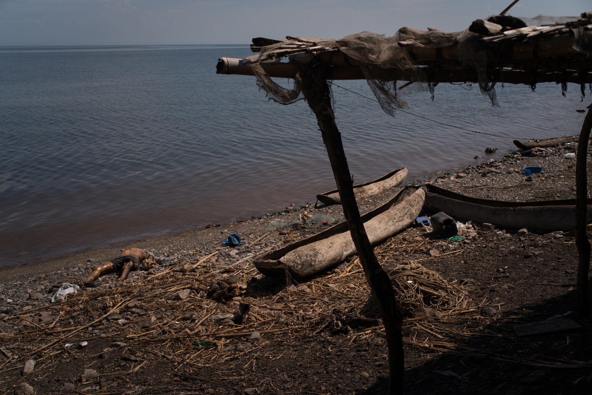  Cadavers line the lakeshore in Joo, one of the villages that was attacked on March 12, leaving reportedly 42 people massacred. This is the body of Justin, 47, a fisherman. The location of the villages - wedged between Lake Albert and mountains - mak