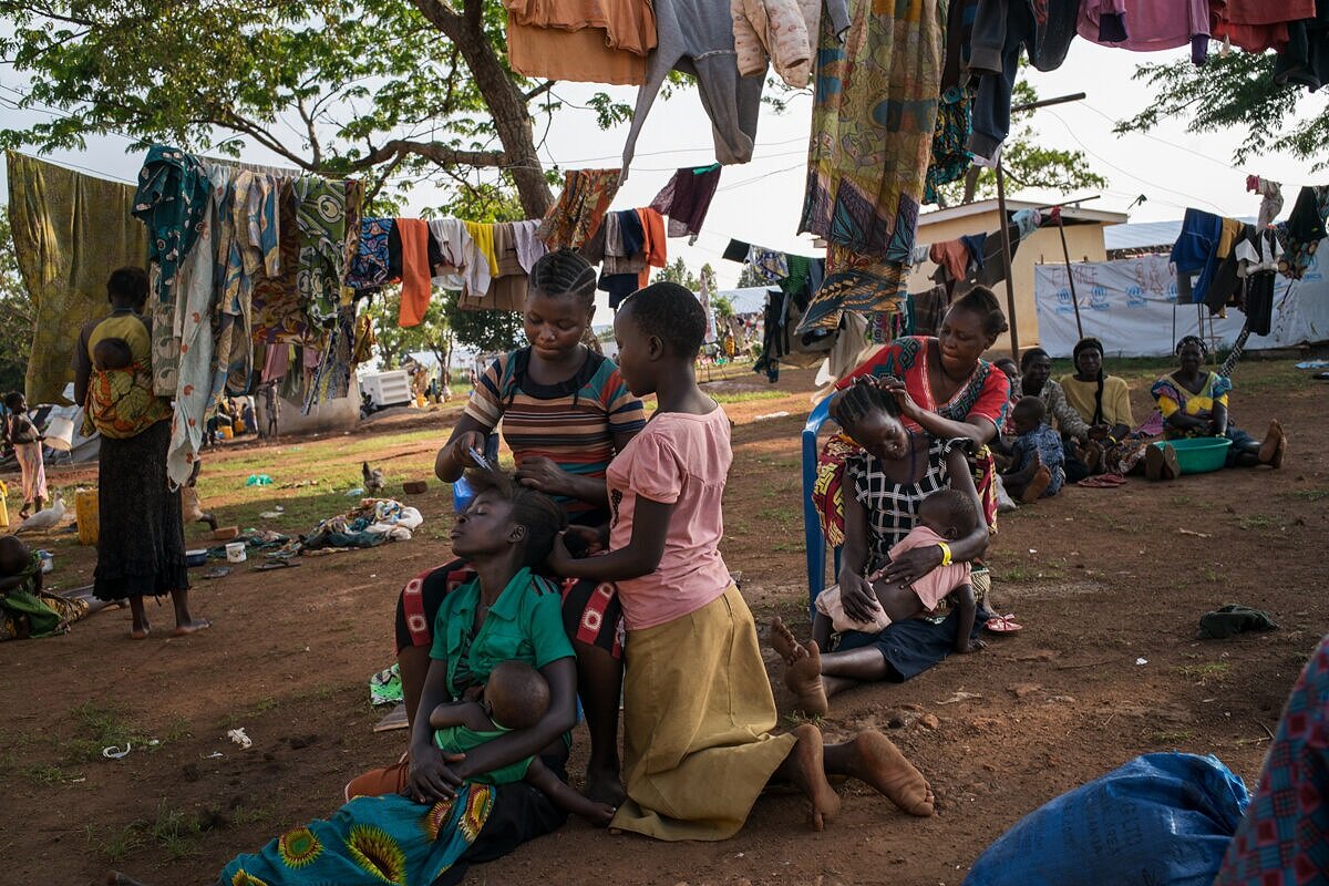  Congolese refugees wait at the reception center in Kyangwali, Uganda, where they spend several days before being transferred to a settlement camp. Between December 2017 and March 2018, over 60,000 refugees arrived to Kyangwali on boats used to cross