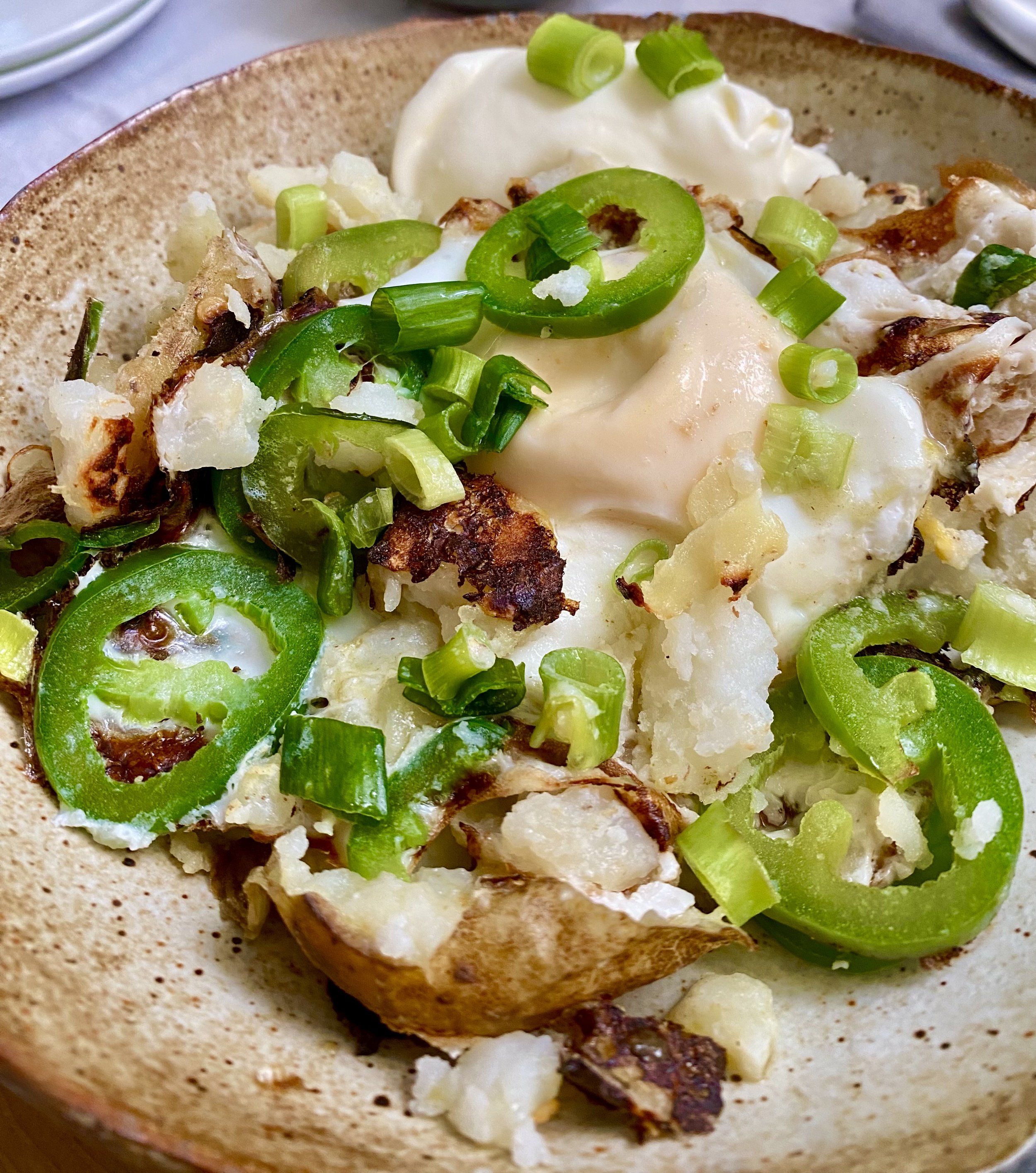 Jalapeño baked potato with egg, green onions, and Crème Fraîche