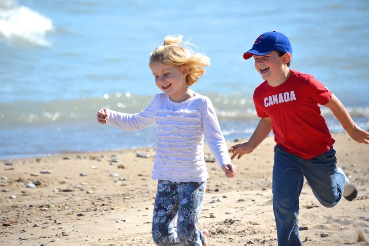 Two kids running on beach .jpg