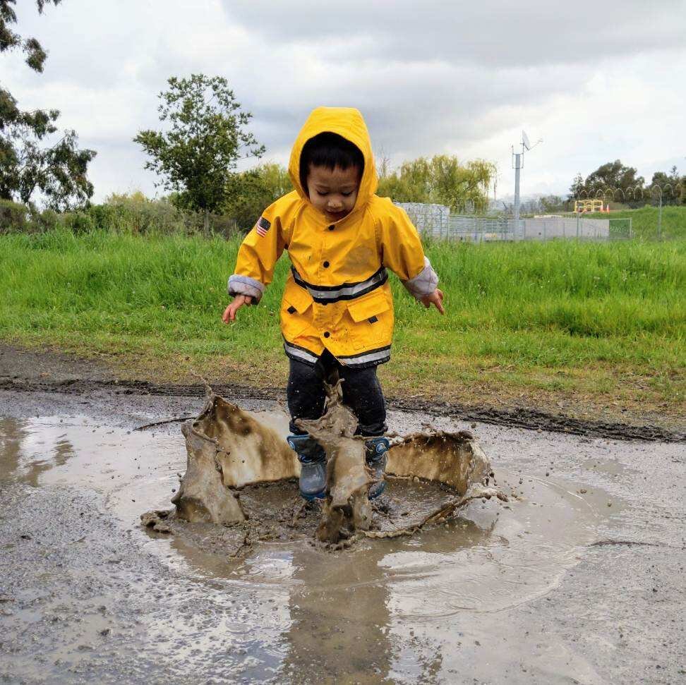 Action shot boy jumping in puddle.jpg