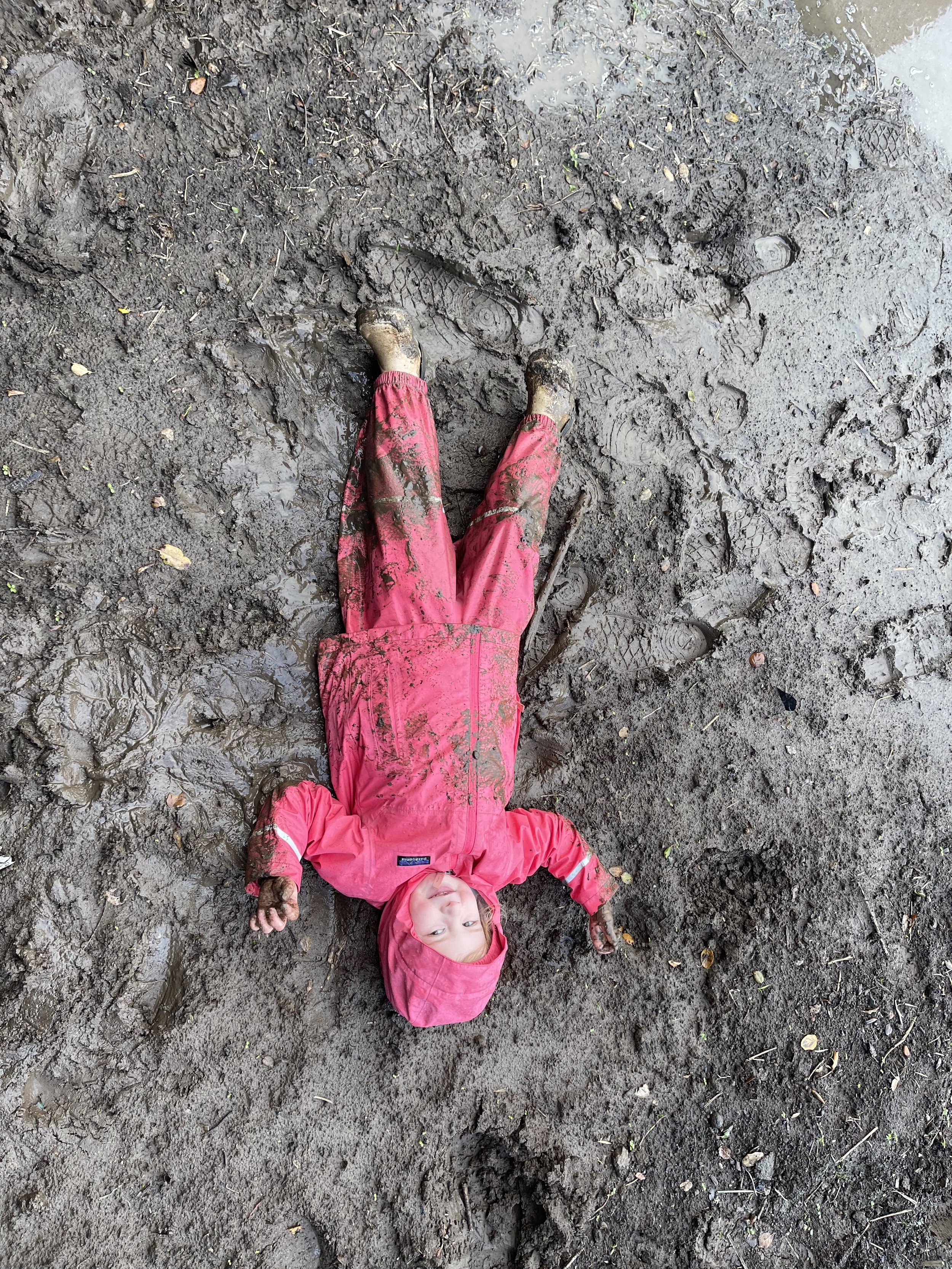 adorable all pink girl lying in mud.jpeg