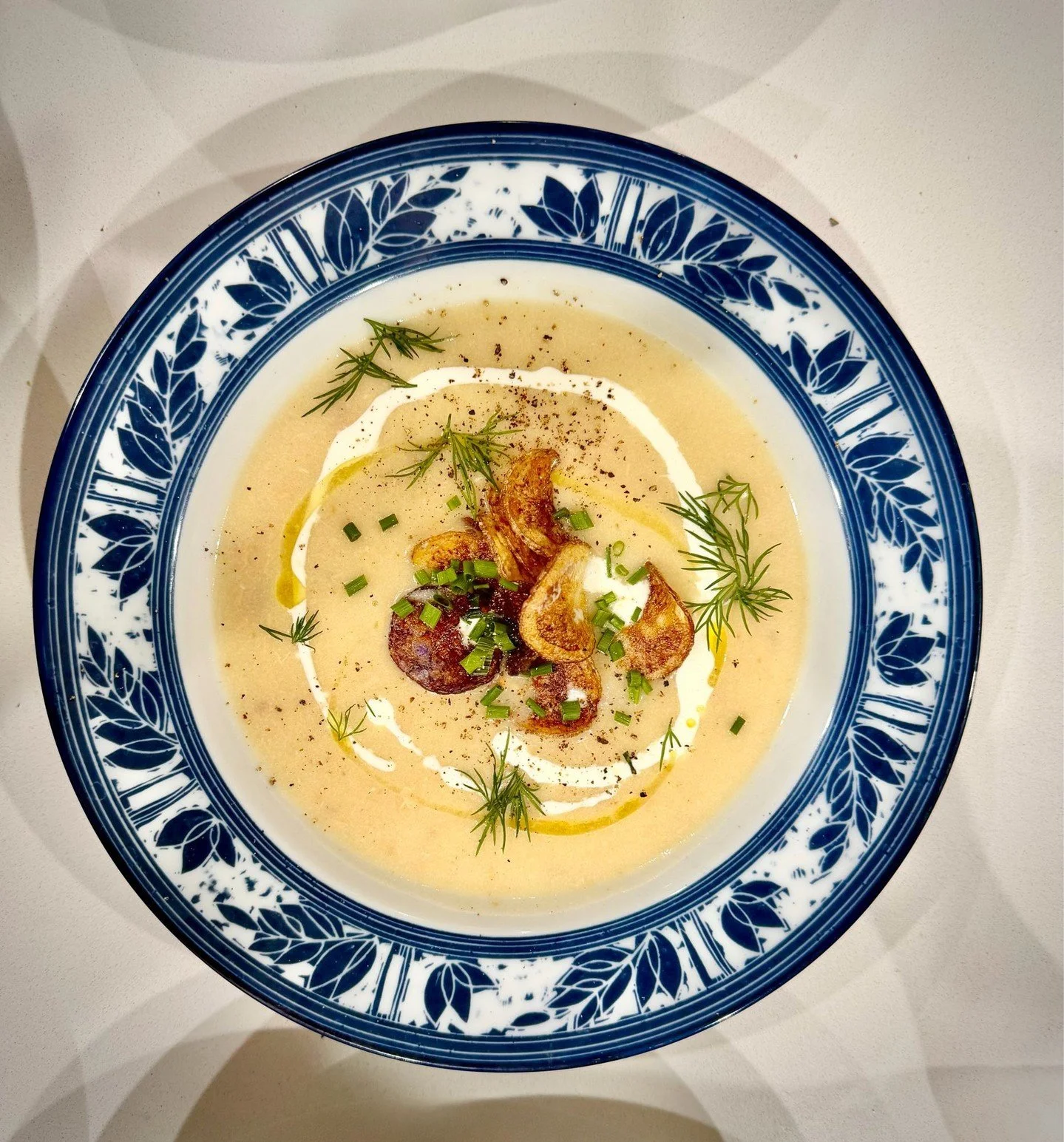Smoked trout chowder for these in-between seasons.

A velvety onion and potato base, folded with house-smoked trout, finished with cr&egrave;me fra&icirc;che, fresh herbs, and a handful of homemade potato chips for texture.
Silky, savory, and deeply 