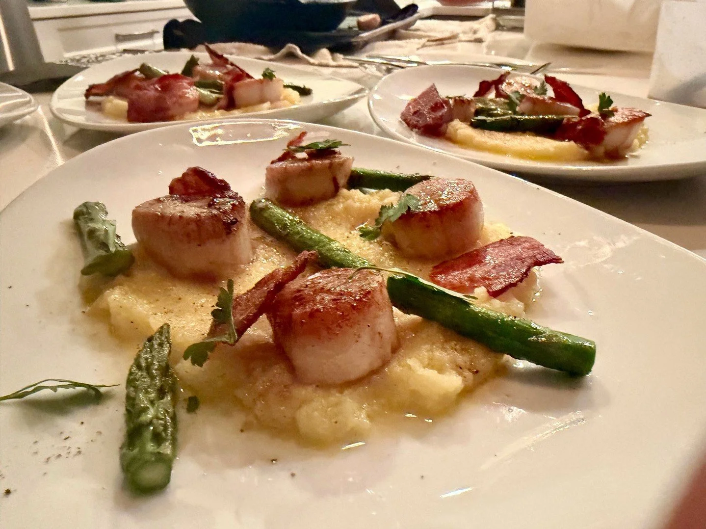 New seasons bring new flavors.

A spring take on a classic &mdash; seared scallops with bacon, asparagus, and a new potato pur&eacute;e, finished with beurre blanc.

Growing up in New England, scallops were always something special &mdash; simple, fr