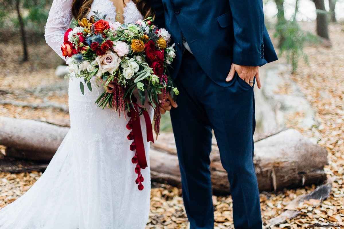 Her bouquet held a mix of garden roses, thistle, orchids, banksia, spray roses, and a ton of greenery. It was absolutely stunning - look at that amazing bauble ribbon!