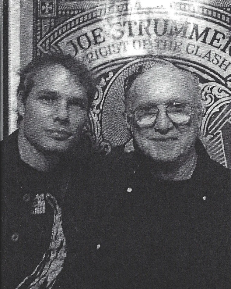 Jack Healey and Shepard Fairey in front of his poster in honour of Joe Strummer.