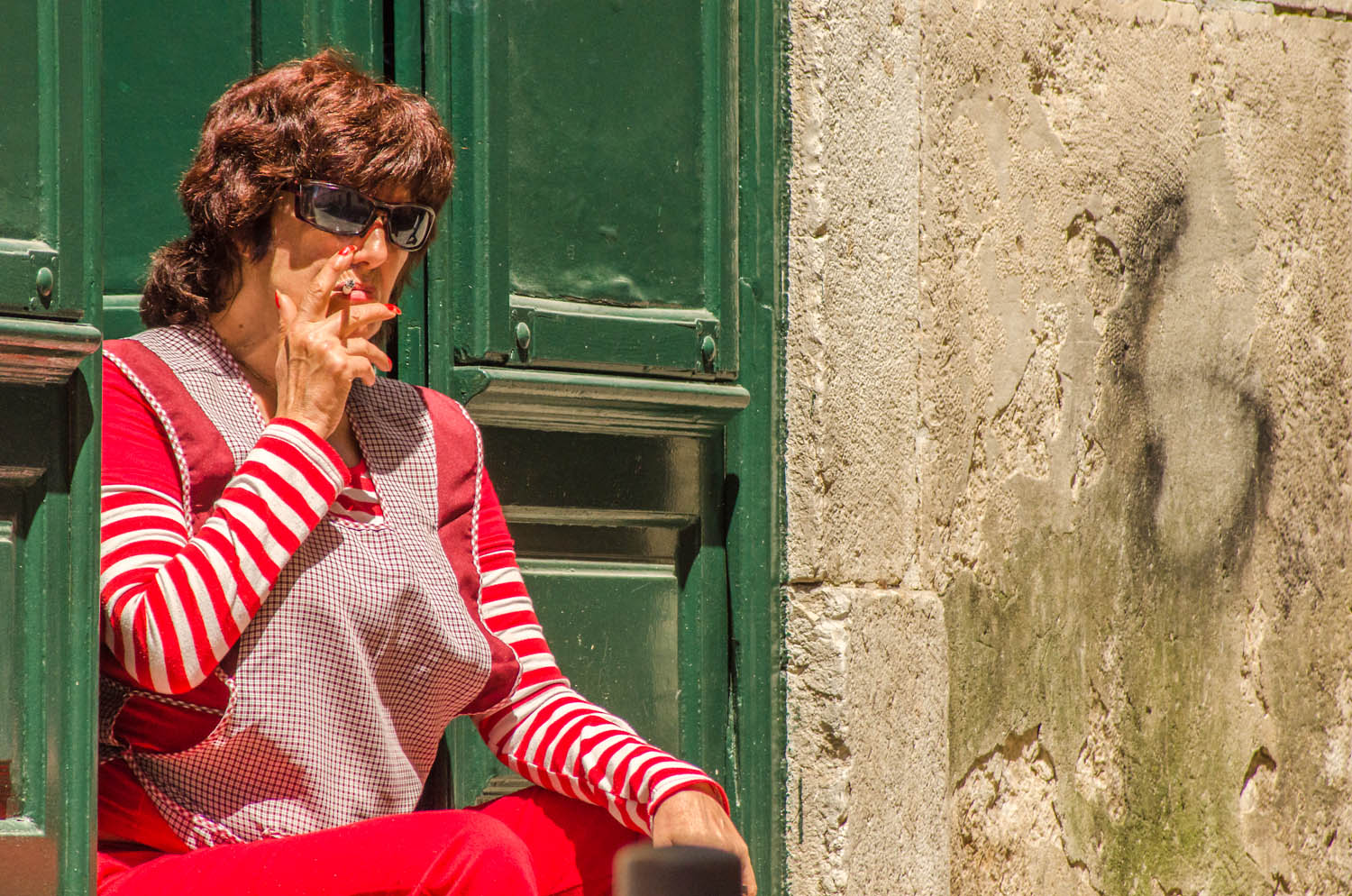 Whenever I take the photo tour to Bairro Alto, Lisbon, I've always found an interesting character. The face alone is very interesting with the glasses and the cigarette but how can you resist the red stripes against the green door. Why didn't I shoot vertically? good question, I don't know why.