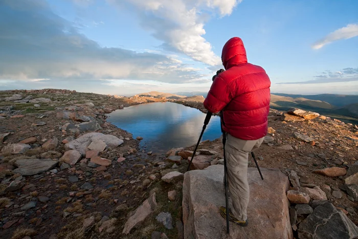 Chris Kayler photographing atop 14,000 ft. tall Mt. Evans during a chilly summer's evening, Colorado.
