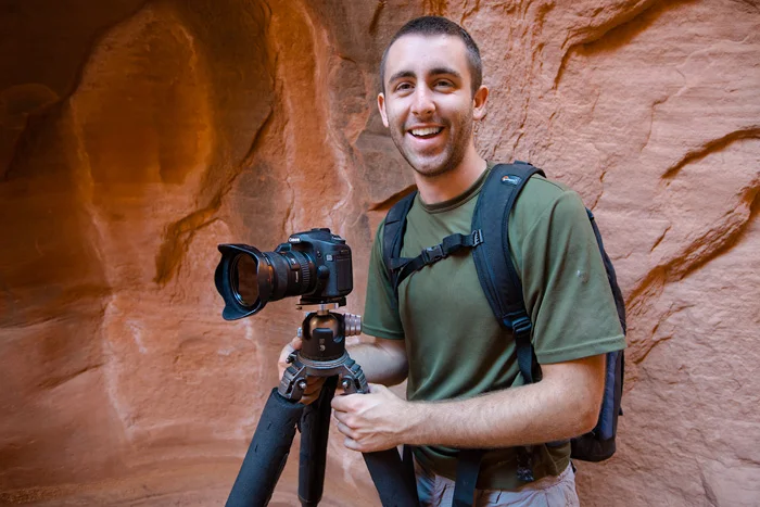 Chris Kayler photographing deep within a slot canyon in Utah.