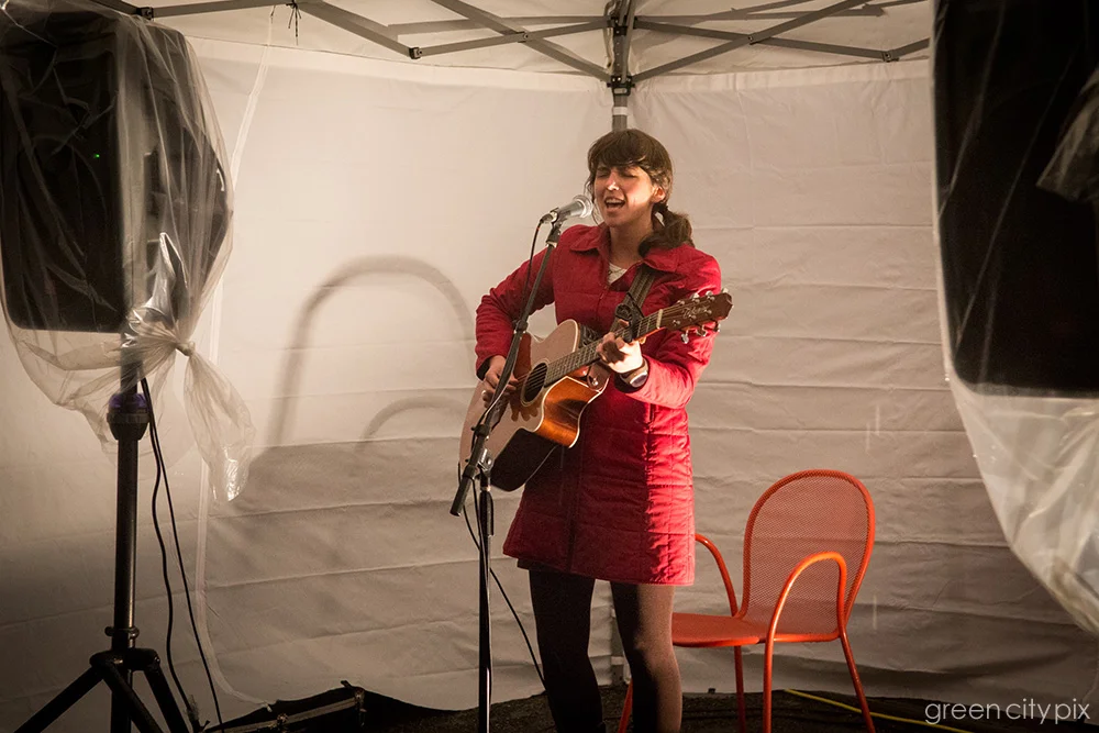 Singer Lydia Ramsey belting out a tune. Her songs convey the wildness of the Northwest and are steeped in the fingerpick-guitar rudiments of folk music. 
