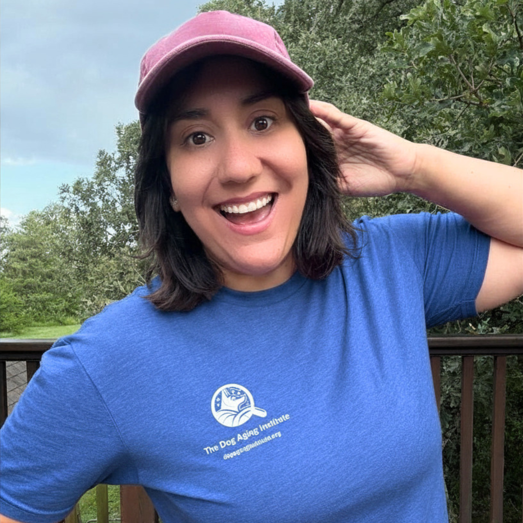 a girl smiling outside in a blue shirt