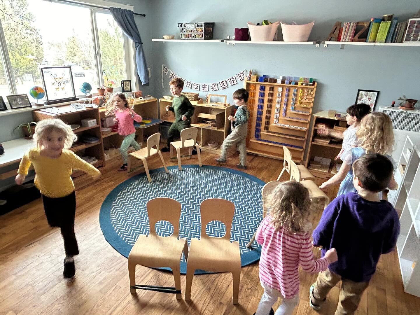 Musical chairs. 

So simple, so fun. 

The children are able to practice so many skills in this game: they help maneuver the furniture, they practice attention, inhibitory control, moving with grace and control, good sportsmanship, and plus some supe
