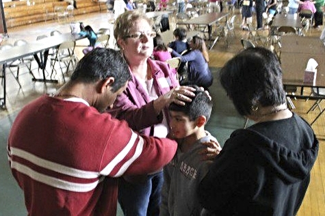 Family praying over kids.jpg