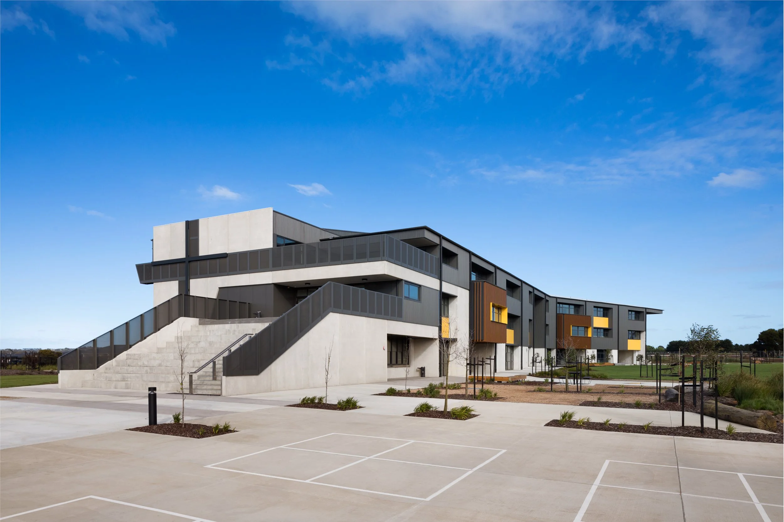 view of Iona college geelong concrete exterior with concrete stairs with down ball squares in foreground designed by clarke hopkins clarke photographed by sarah anderson photography geelong for kildare construction group