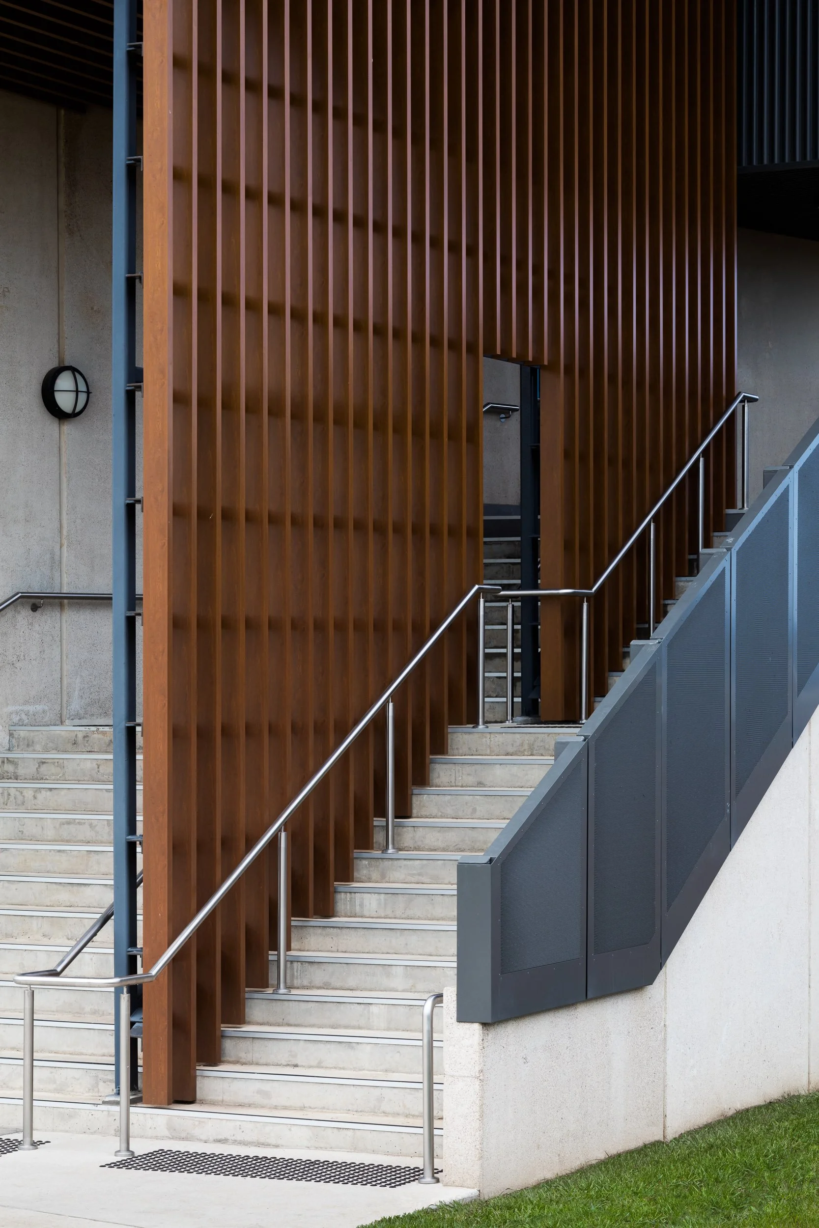 detail of concrete stairs and batten railing at iona college geelong with architecture by clarke hopkins clarke photographed by geelong photographer sarah anderson photography for kildare construction group