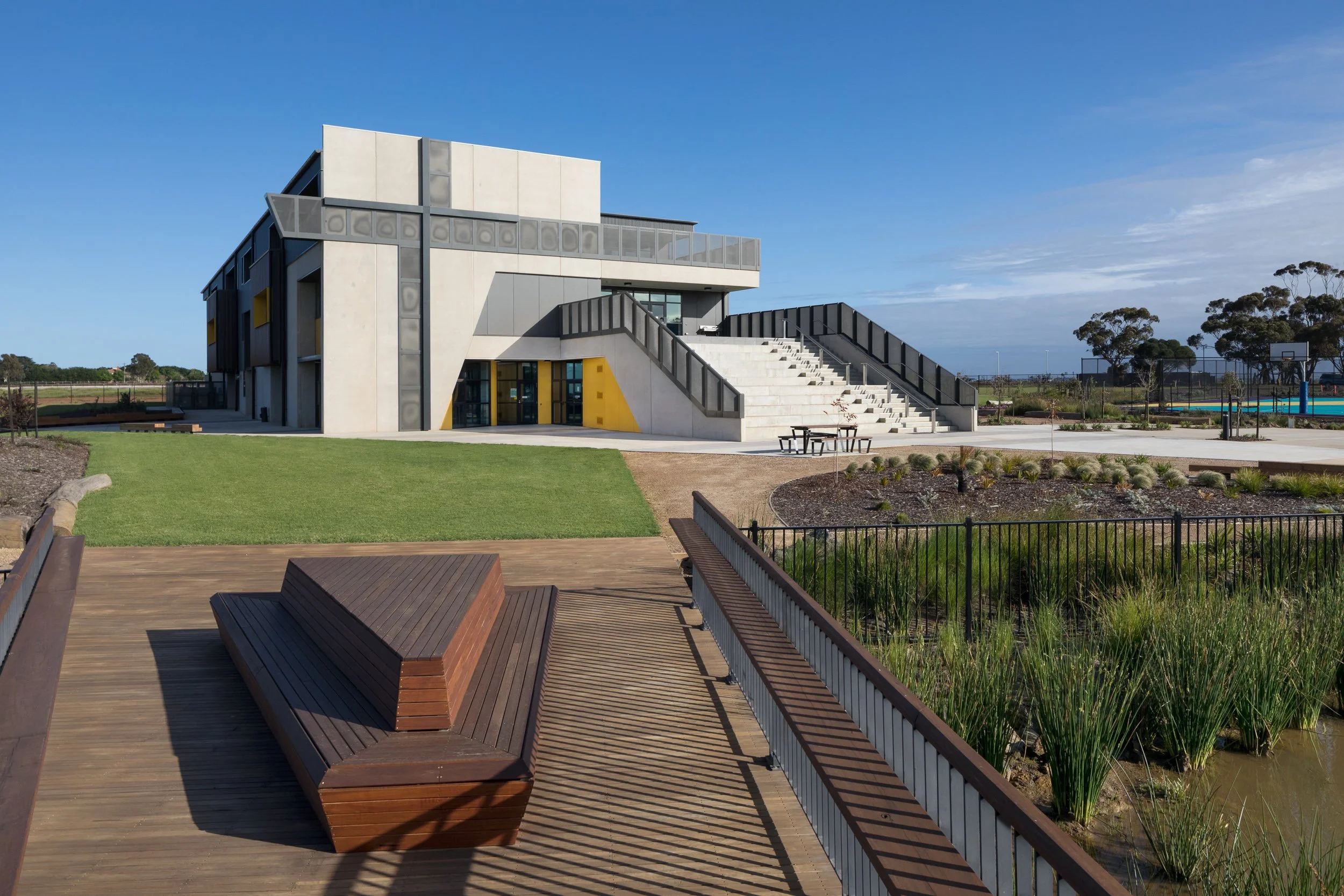 Iona college geelong with custom wooden bench built by kildare construction group and bridge in foreground design by clarke hopkins clarke, photographed by Sarah anderson photography geelong for Kildare construction group geelong