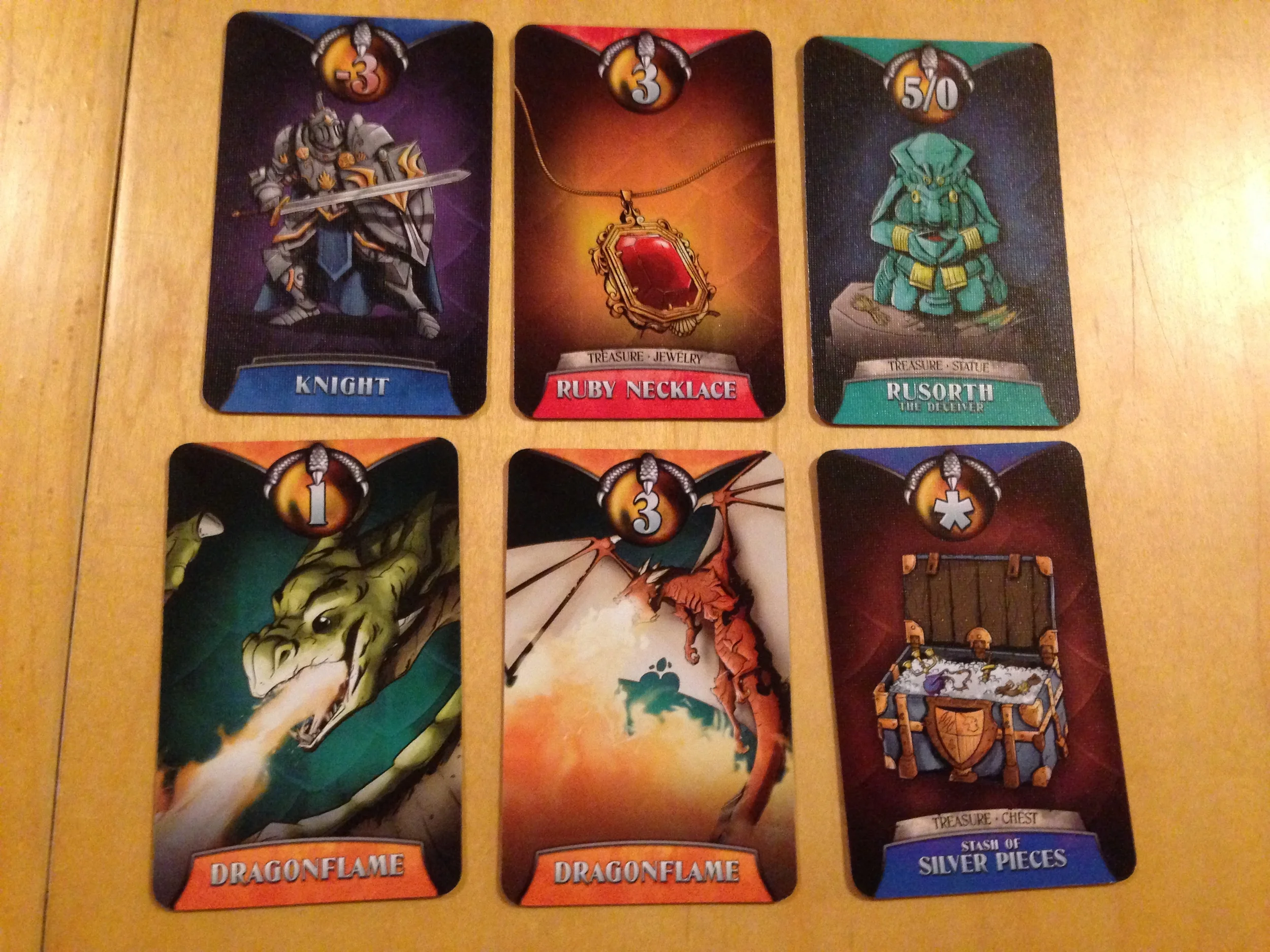 Some Treasure cards. Note the Knight who costs you points. BAD KNIGHT!