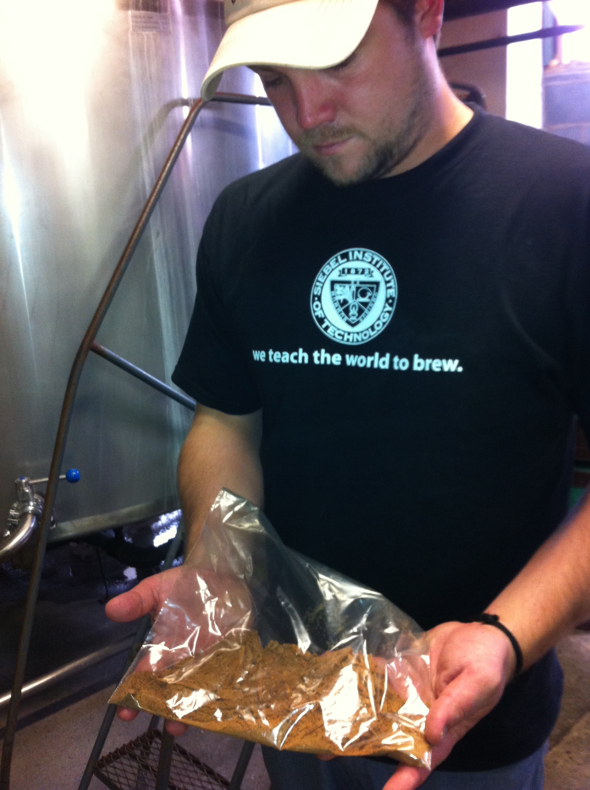 Roy with a special blend of cinnamon, clove, nutmeg and ginger. He's about to throw it into the kettle to boil it. This makes the entire brewery smell AMAZING.