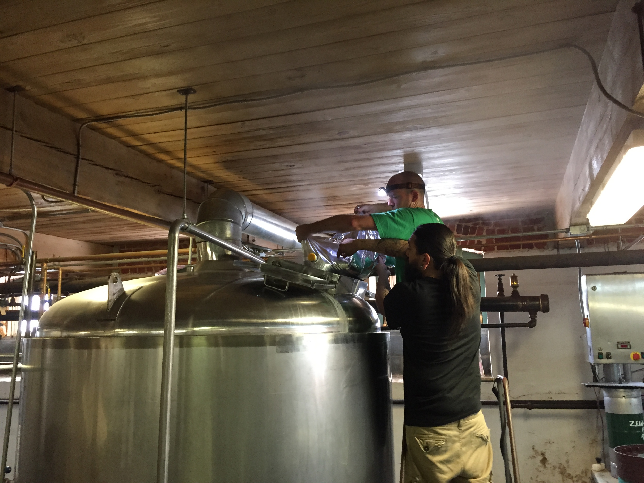 Chris and Berto adding blueberry to the kettle for the Schnozberry Lager