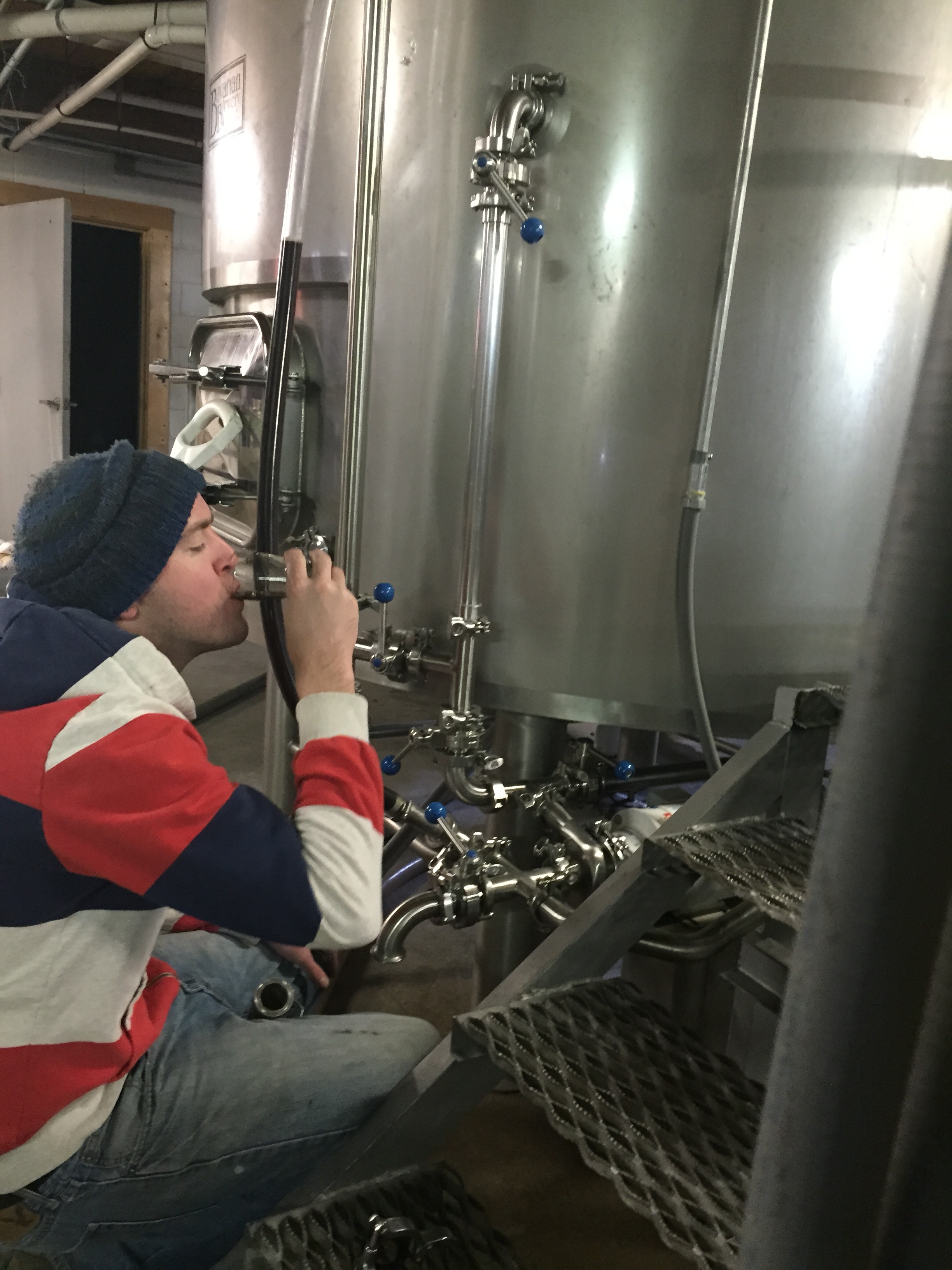 Brewer Chris sampling the wort from the Safety Stout!