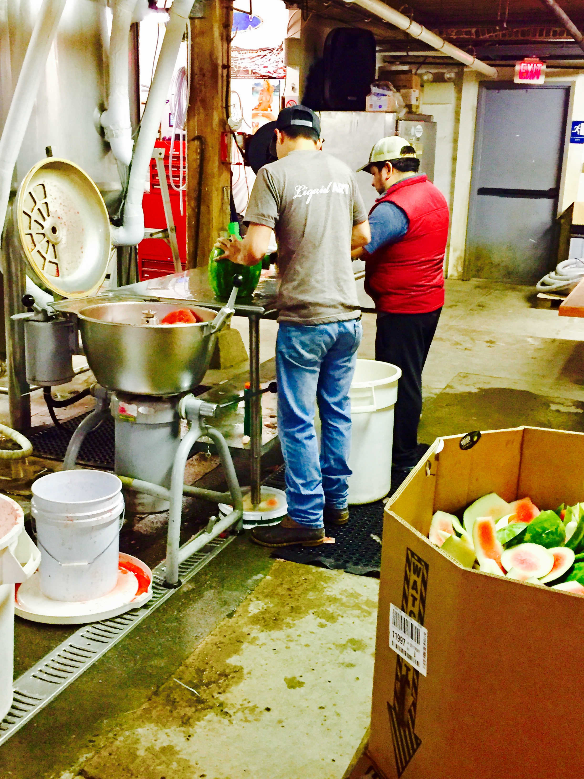Khoi and Gus slicing some fresh watermelon for the brew