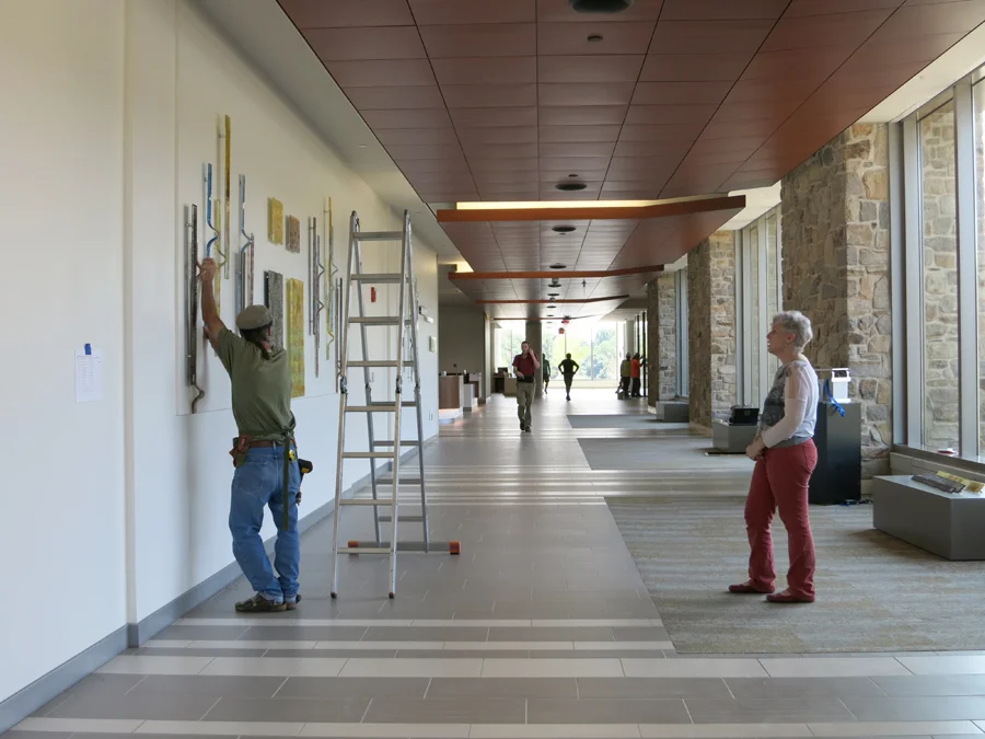 Installer Clifford Wheeler installed the pieces while Kari confirmed placement.