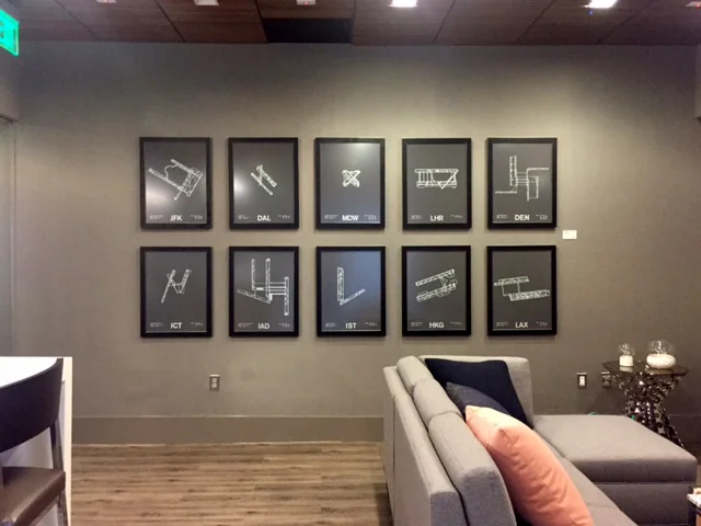 This series of prints, installed in the lounge area, feature the floor plans of airports. 