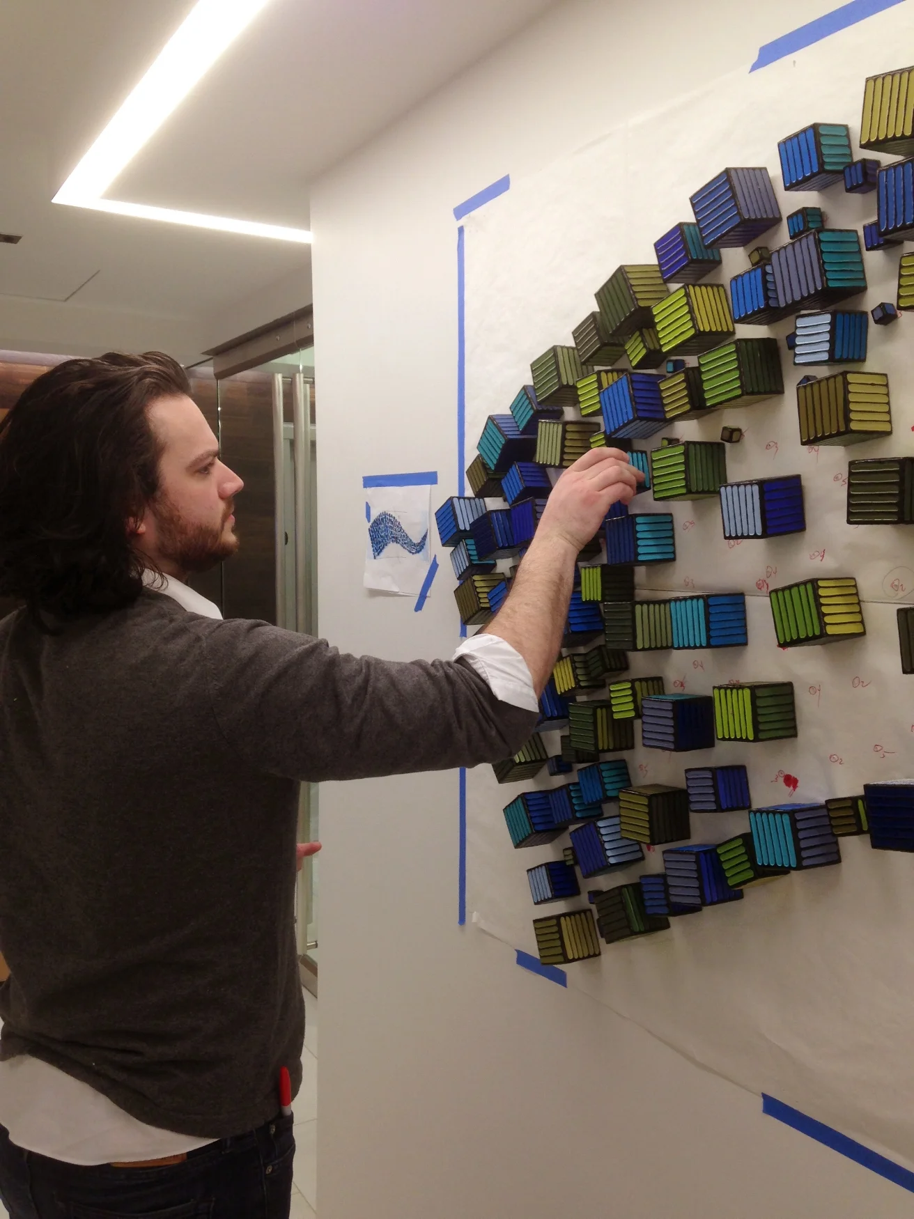 Just a few days into the job, Keenan is installing a complex wall sculpture for one of our clients in Bethesda.