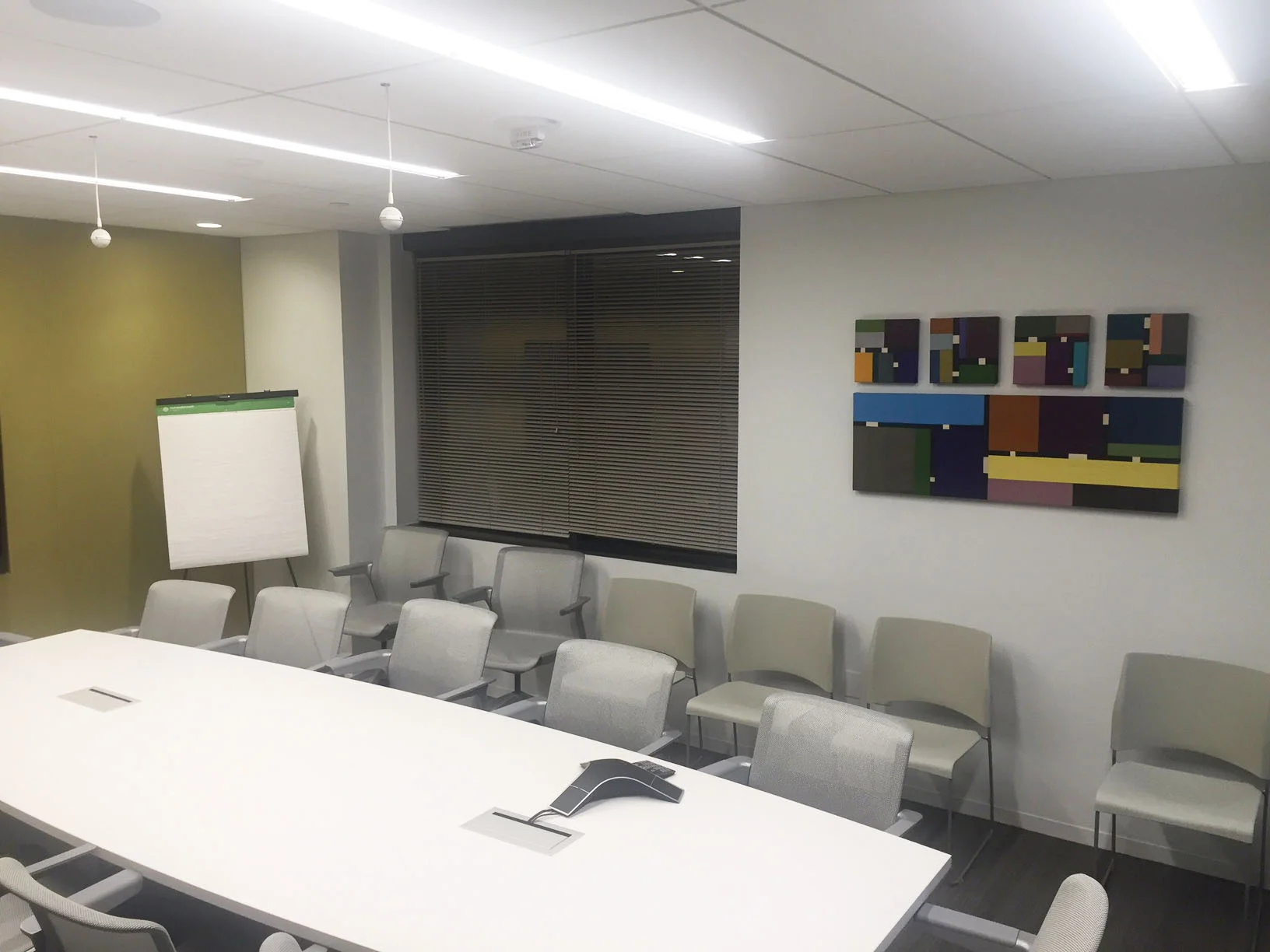 Artists Circle commissioned a textile artist to create unique work for the main conference room to accent the fabric wrapped walls, seen above. 