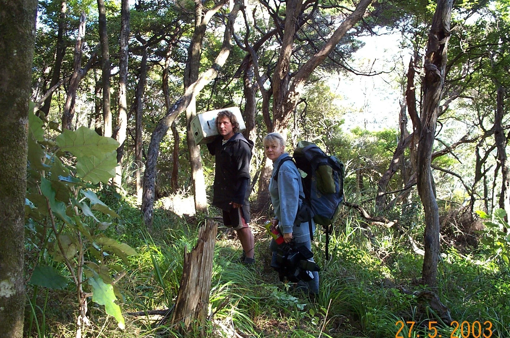   Dean Medland and Judy Gilbert carrying rat traps in Windy Hill Sanctuary (2003)  
