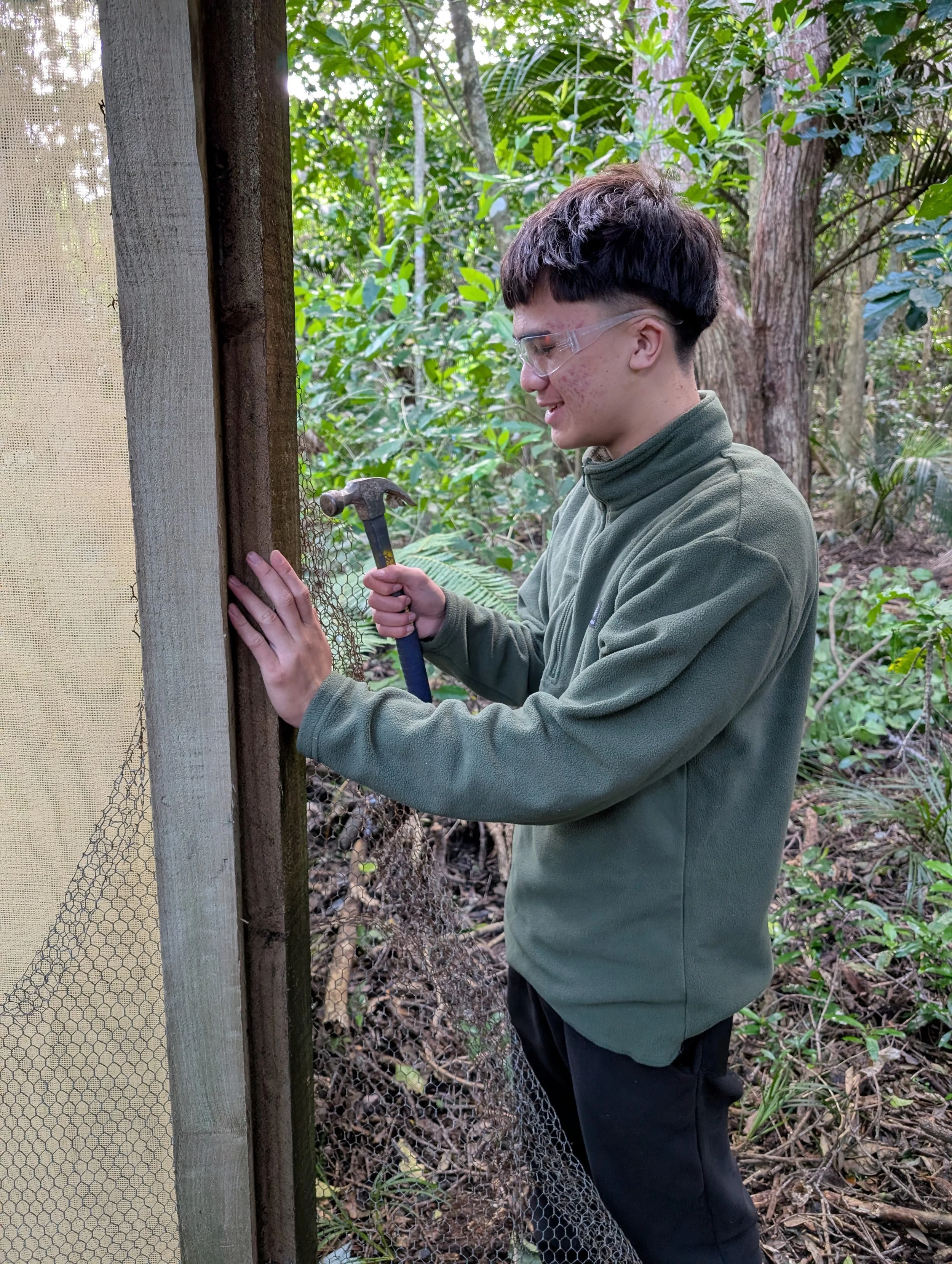   Kanoa Ngawaka-Tamihana helping prepare aviary (Credit: Kevin Parker)  