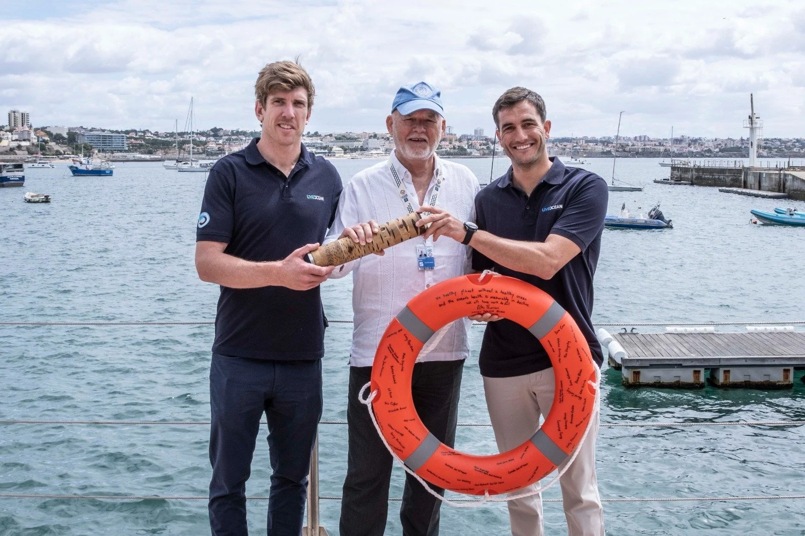   Pete Burling and Blair Tuke, founders of Live Ocean and advocates for the Hauraki Gulf, with the UN Special Envoy for the Ocean, Peter Thomson at the UN Ocean Conference in Lisbon. They hold ‘Nature’s Baton’, which has messages of hope and ambition from leaders, scientists, and advocates ... and the ‘Ring of Life’ - signed by sports men and women around the world who support the Live Ocean commitment to a healthy and productive ocean. It is an example of international outreach and connection that New Zealand can be proud of (Photo: New Zealand Geographic.)  
