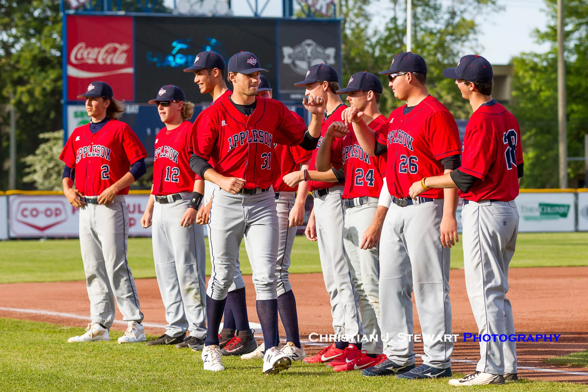 Photo Courtesy of Christian J. Stewart Photography - Dylan Grogan bumps fist with AppleSox teammates before June 5 game at Victoria. The AppleSox won 9-4.