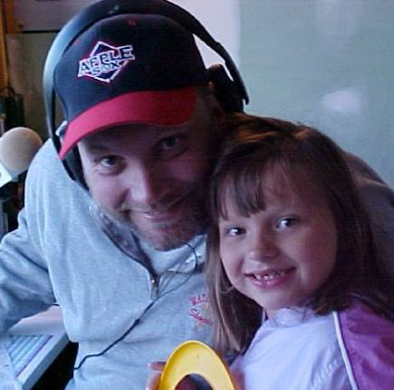 Eric Granstrom, the ‘Voice of the AppleSox’ from 2000-06, will broadcast four Sox games for the NCWLIFE Channel this summer. Here he is pictured with his daughter, Gracie, in the broadcast booth in 2003.
